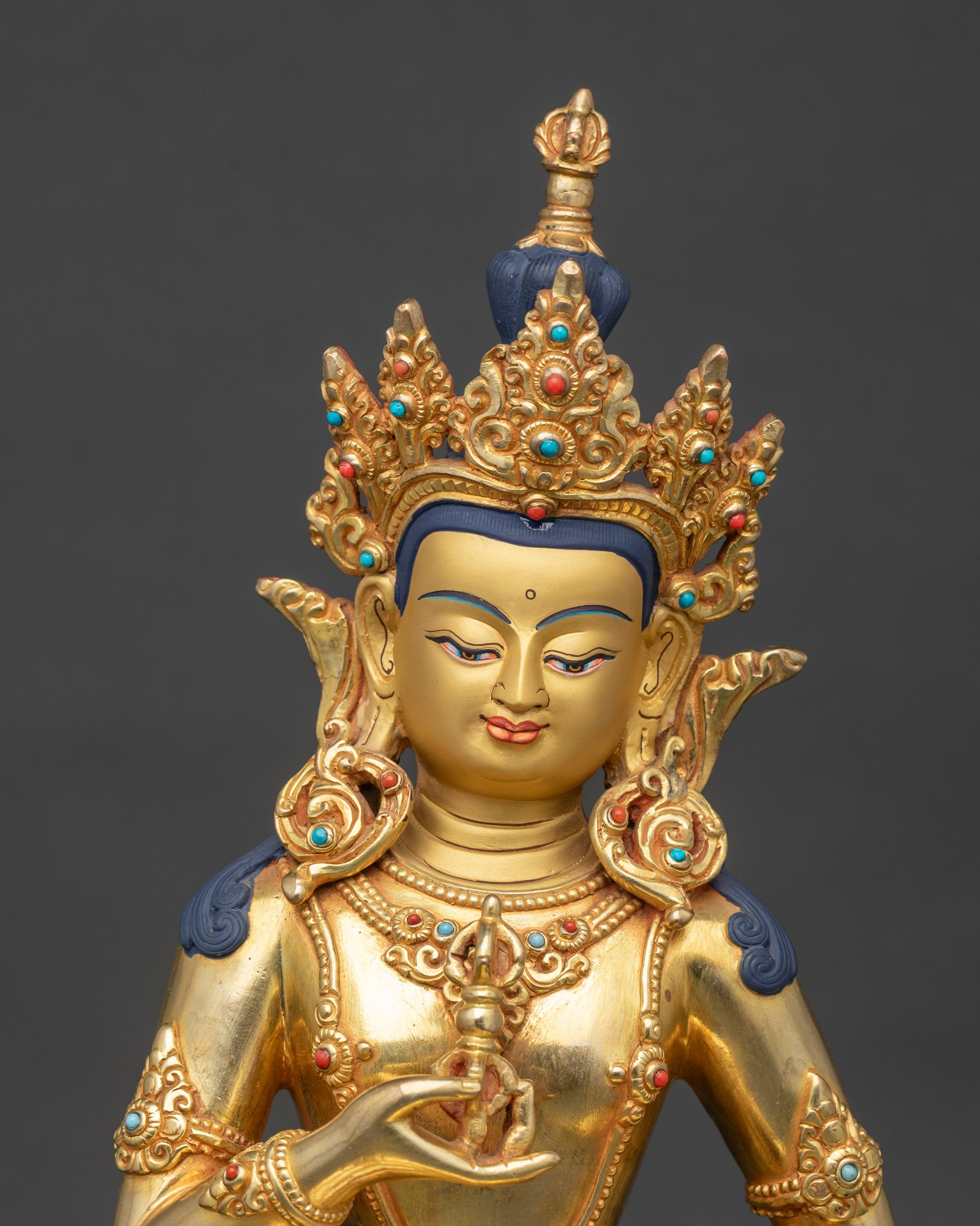 Close view of Vajrasattva statue showing intricate crown and flowing robes