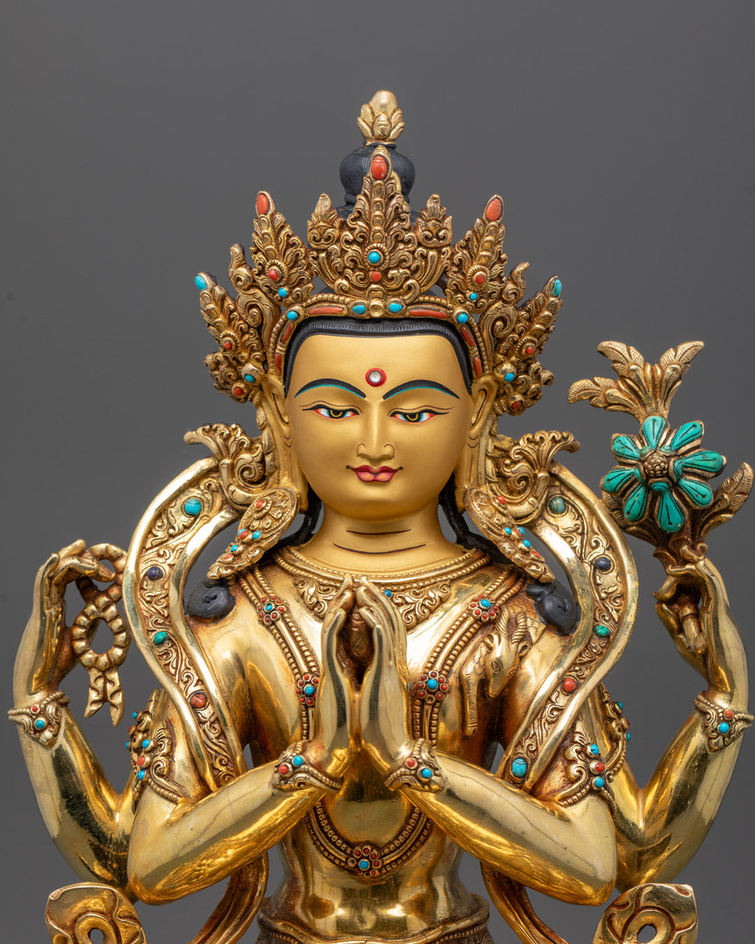 Closeup of Chenrezig Statue’s gold fire-gilded body and intricate semi-precious stone details