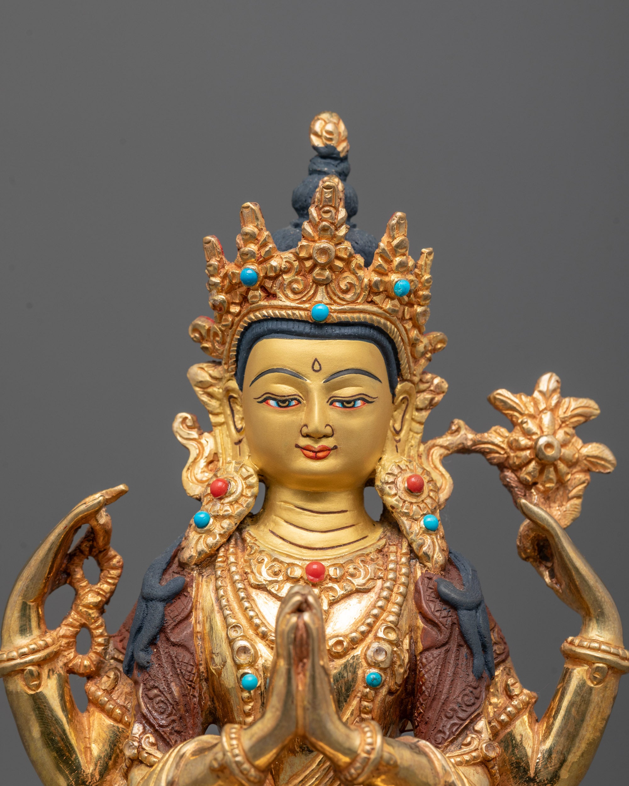 Closeup of Chenrezig statue’s wish-fulfilling gem and detailed gold Fire-gilded body carvings.