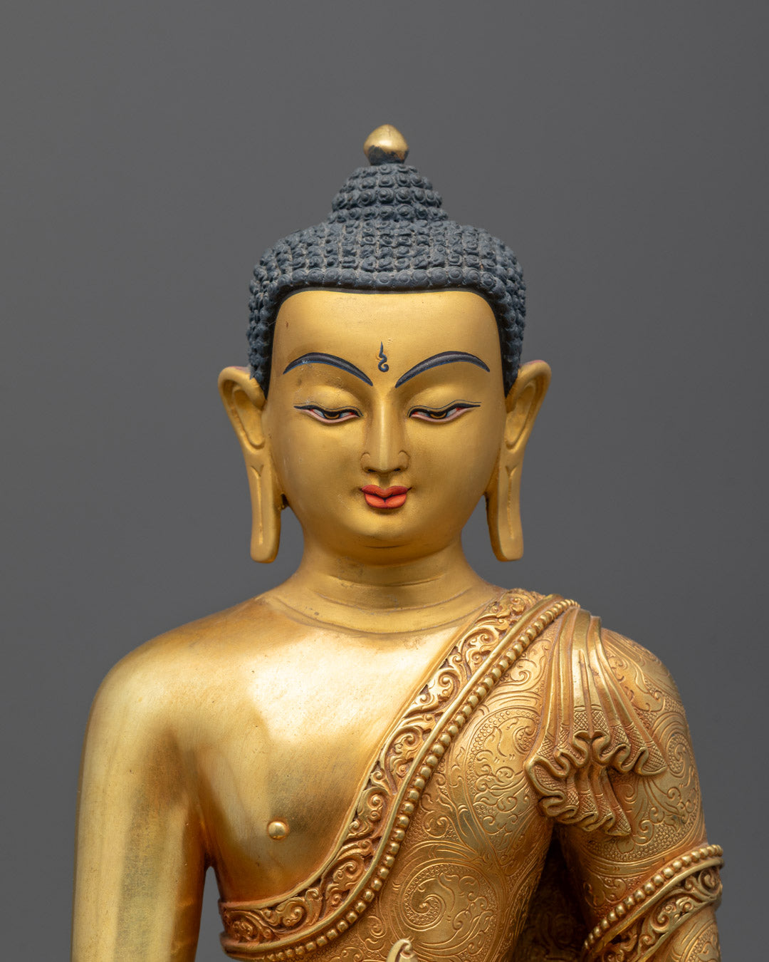 Closeup of Medicine Buddha statue showing intricate hand-carved details