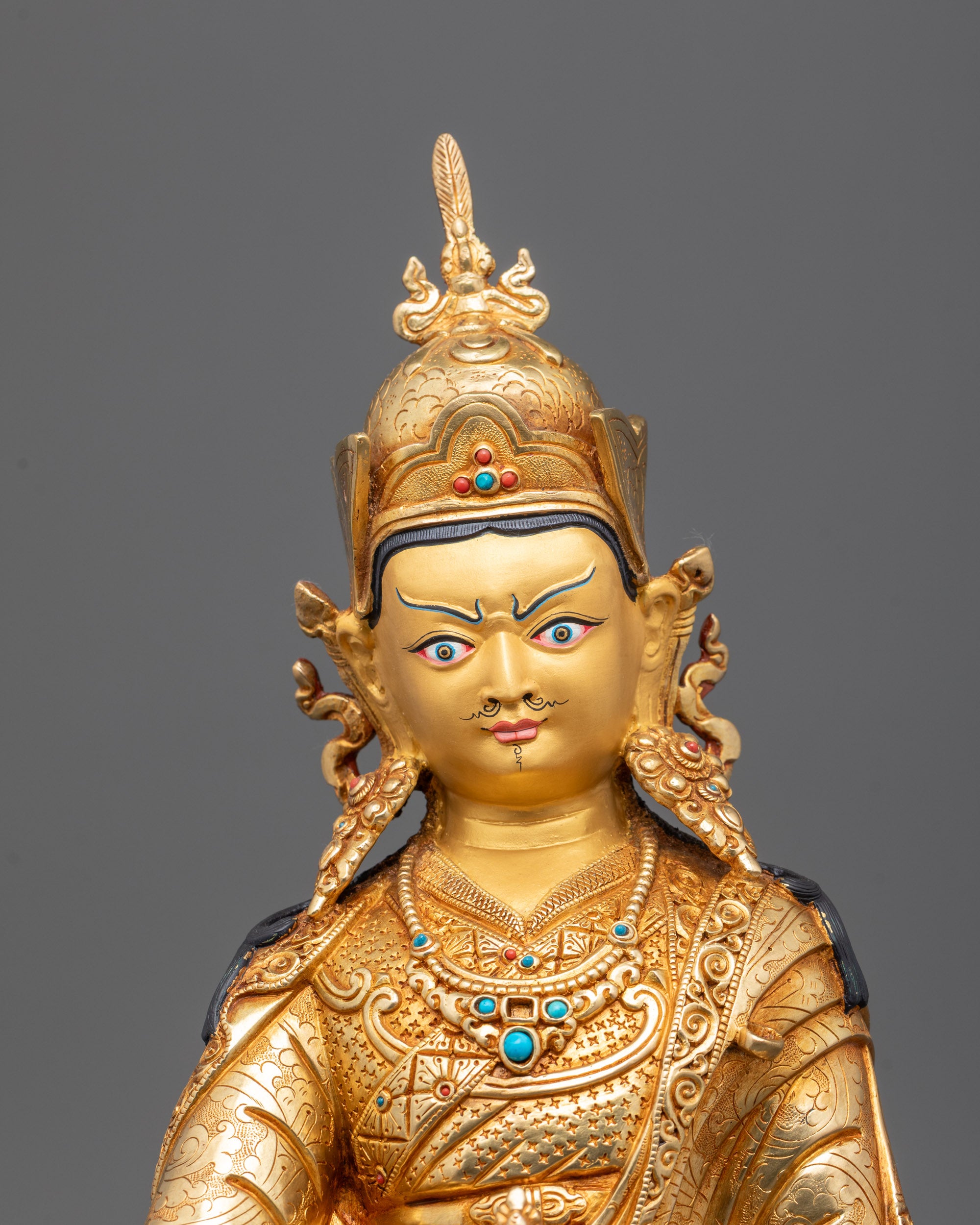 Closeup of Padmasambhava statue’s Vajra, skull vase, and semi-precious stone details
