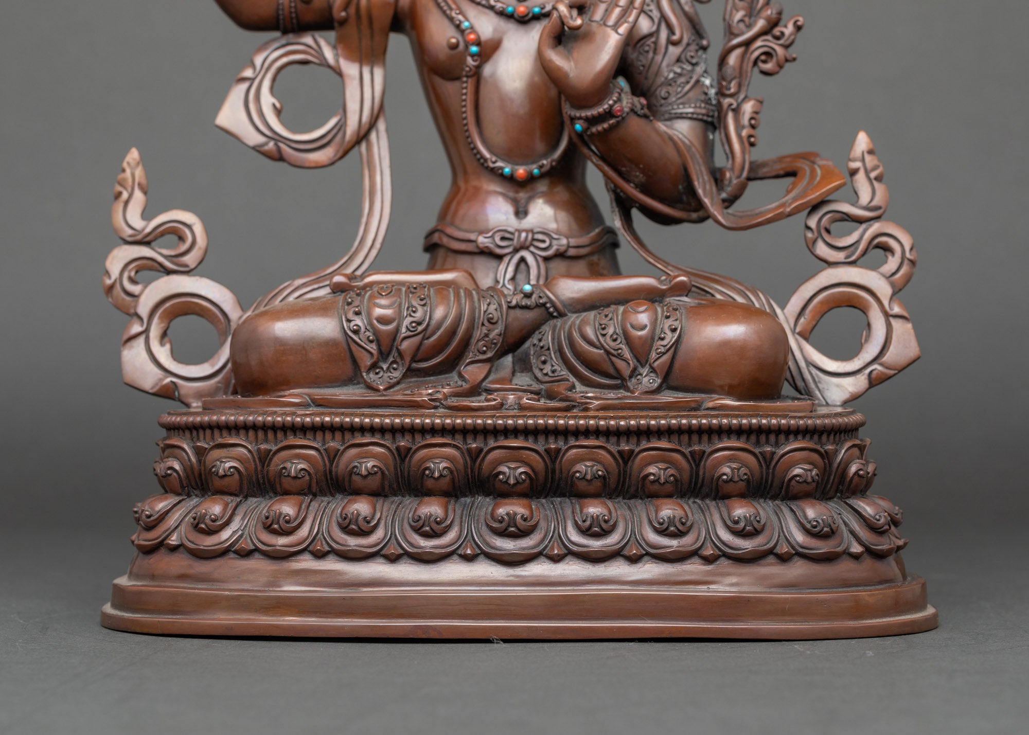 Detail of flowing robes and lotus base, handcrafted Nepalese Manjushri meditation statue