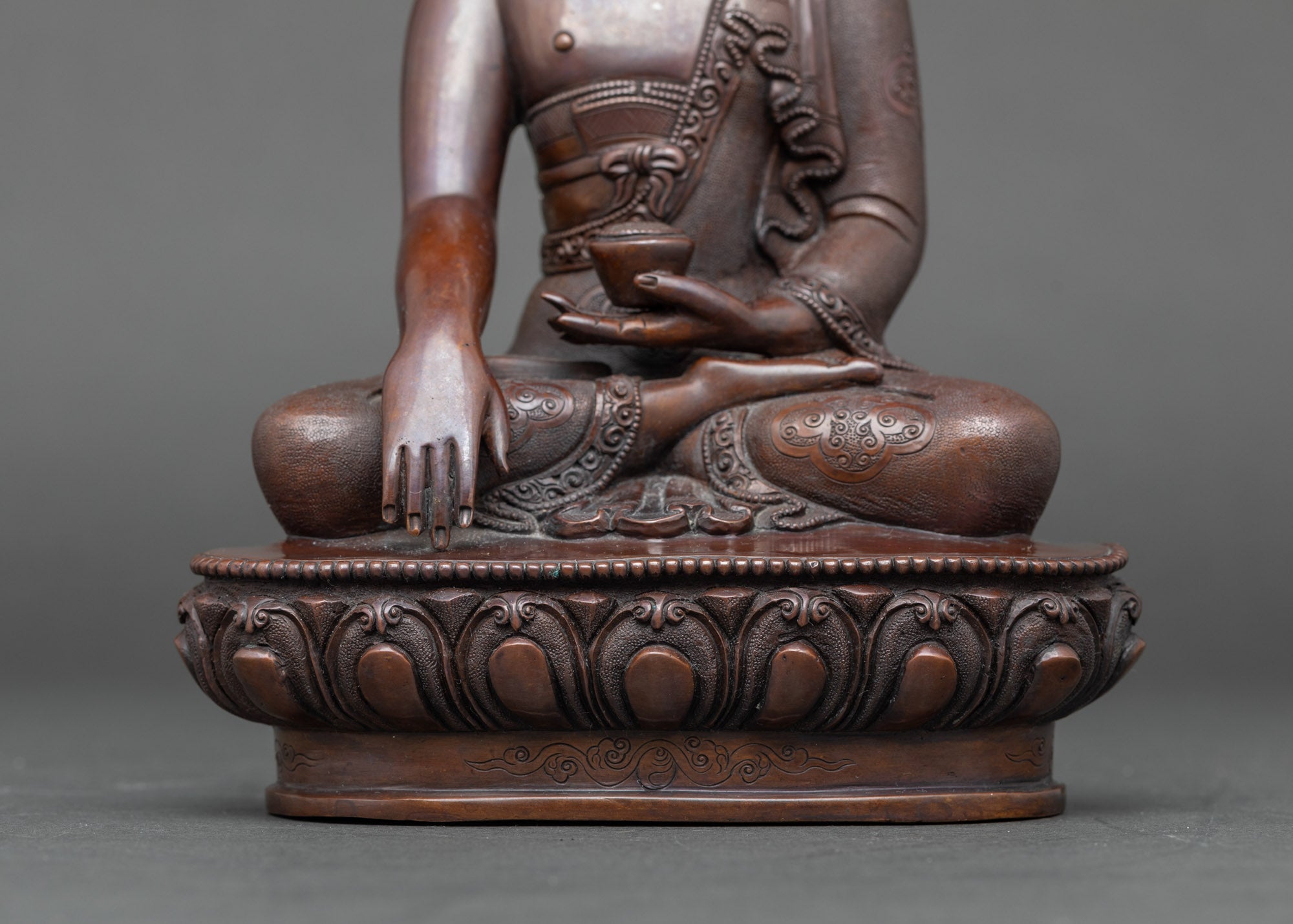 Detail of intricately carved lotus base, handcrafted Nepalese Buddha