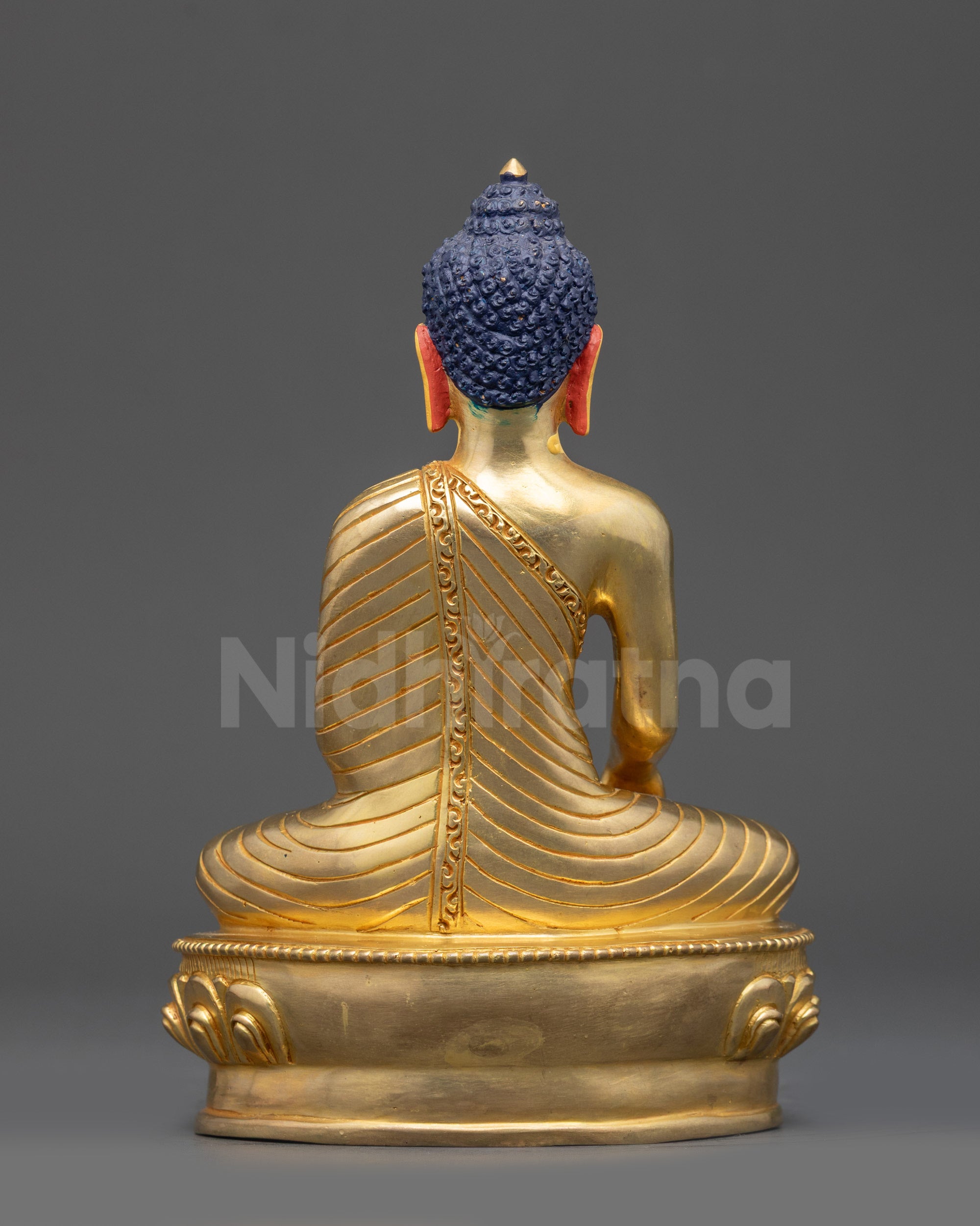 Detailed angle showing lotus seat and gold-gilded craftsmanship of Buddha statue