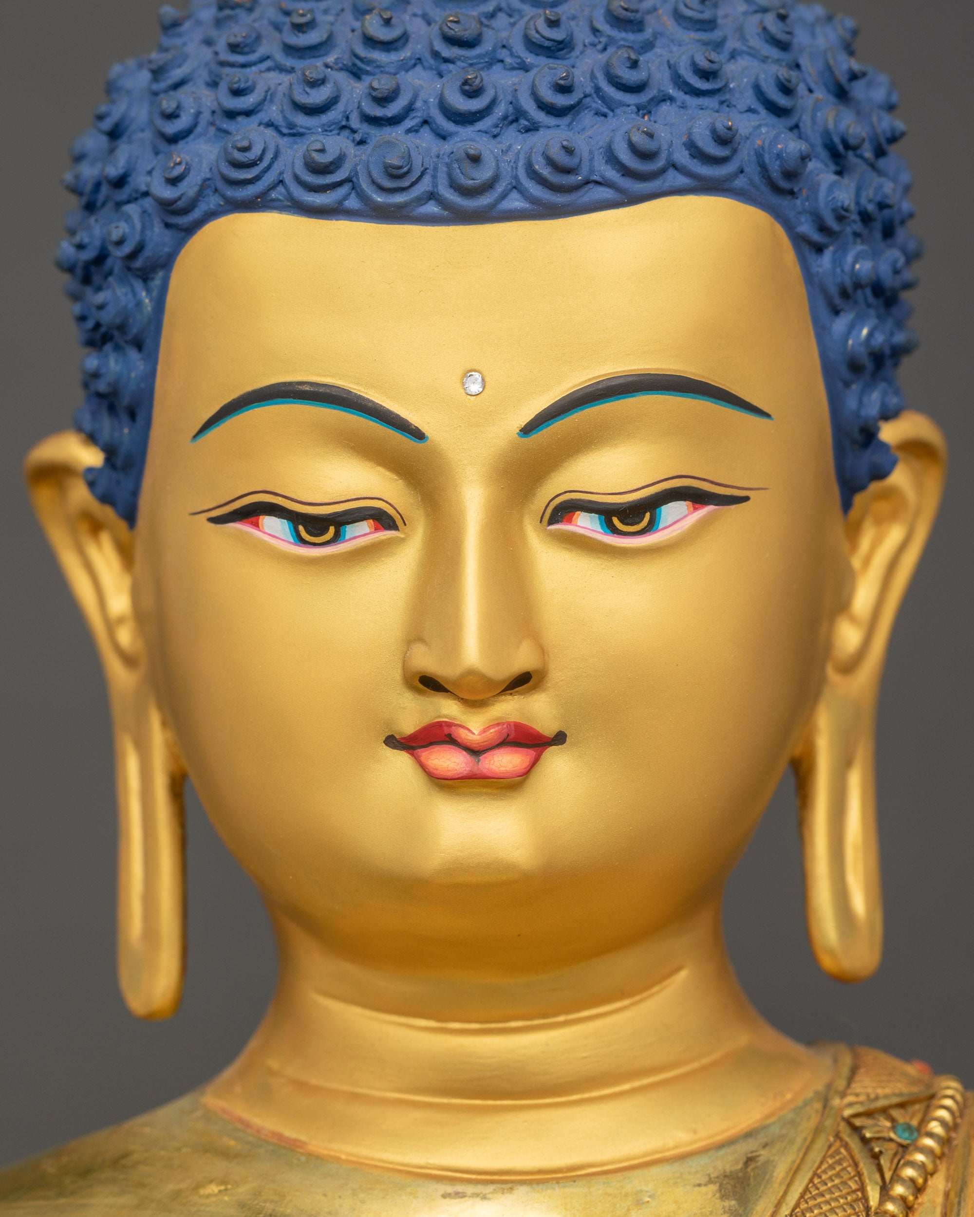 Detailed close-up of Buddha’s serene gold-gilded face with peaceful expression