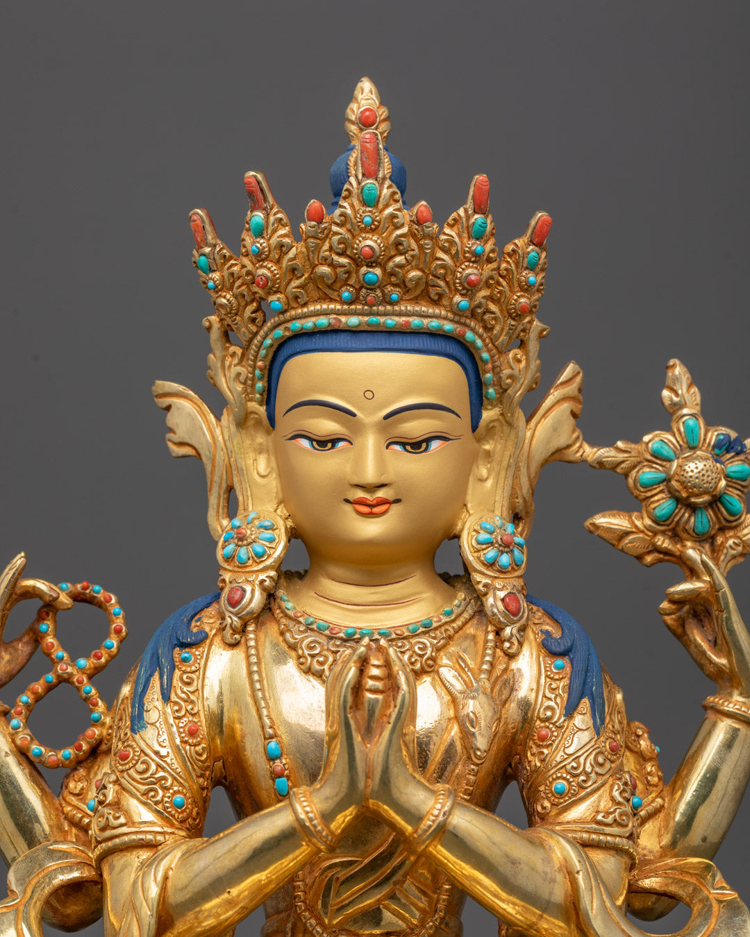 Detailed close-up of Chenrezig Buddha statue showing serene face