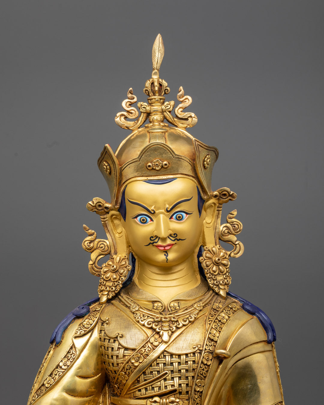 Detailed close-up of Guru Rinpoche Statue showcasing intricate hand-carved features and vibrant semi-precious stones.