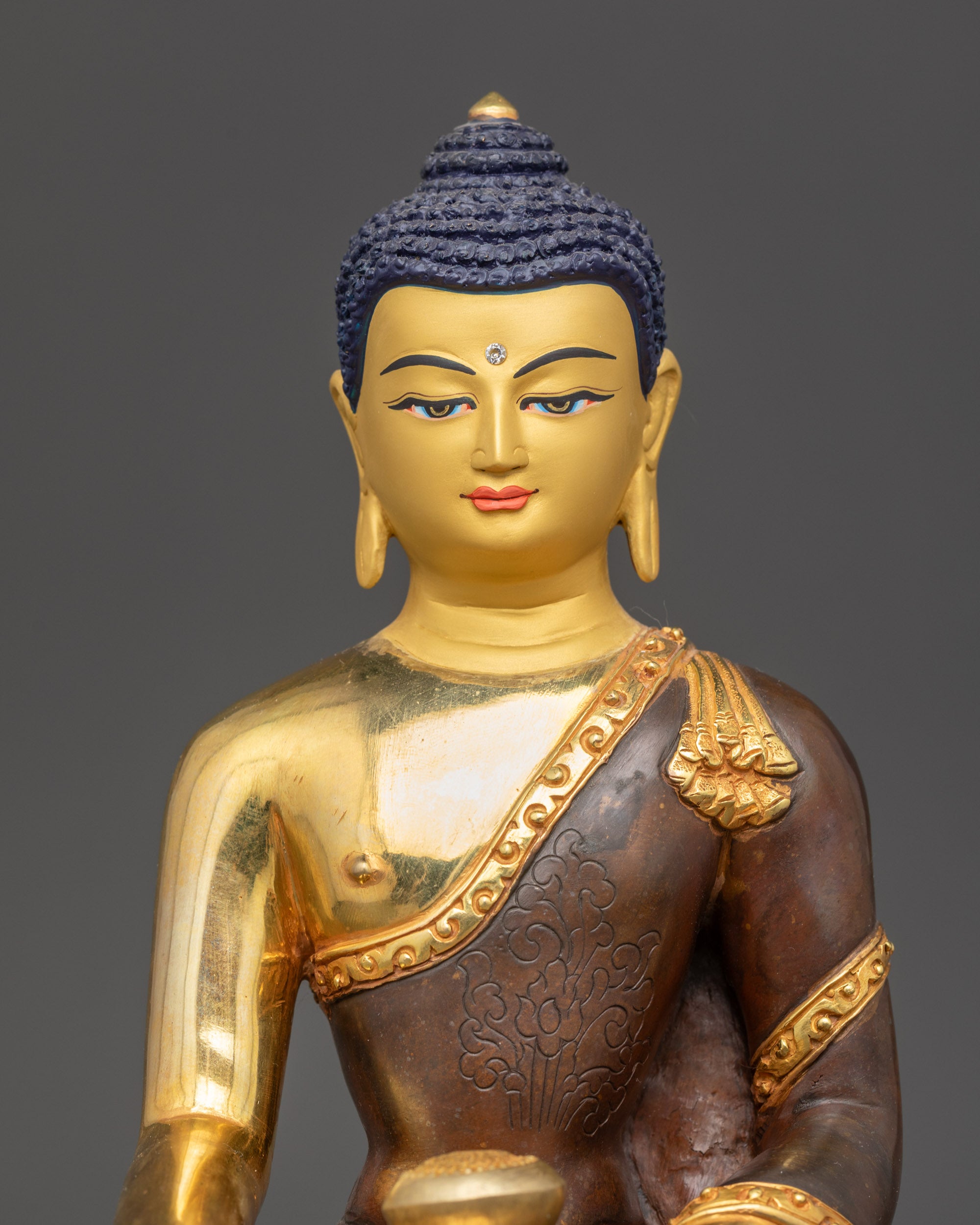 Detailed close-up of Shakyamuni Buddha face with gold paint and Acrylic Colors finish