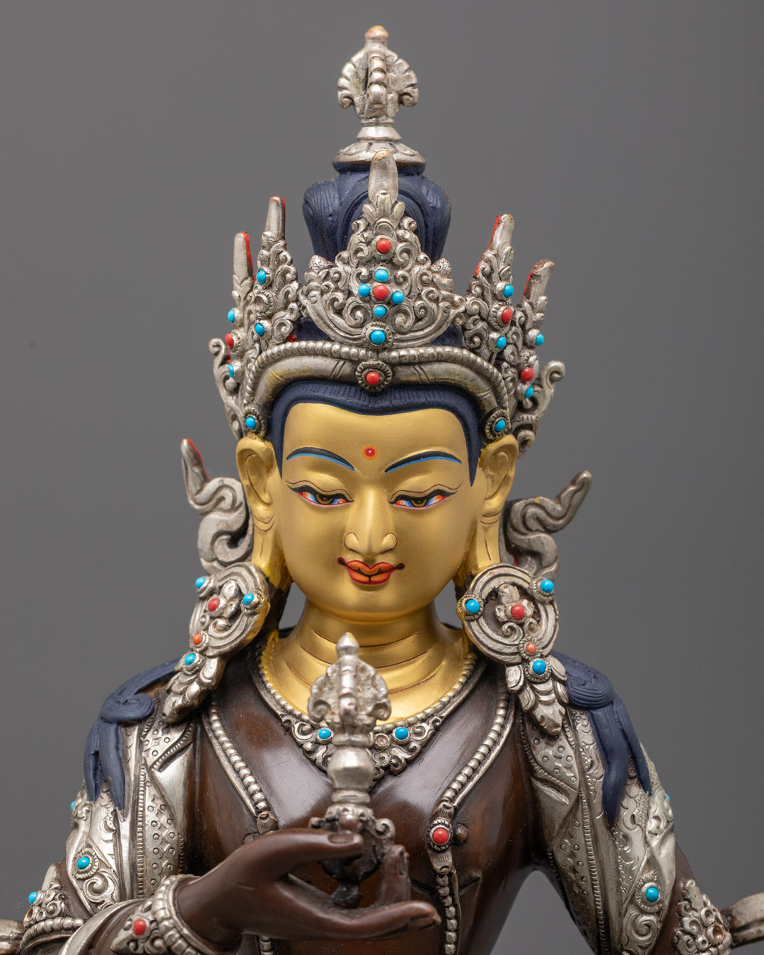Detailed close-up of Vajrasattva’s 24k gold-gilded face, adorned with an intricately designed crown and multi-colored acrylic accents.