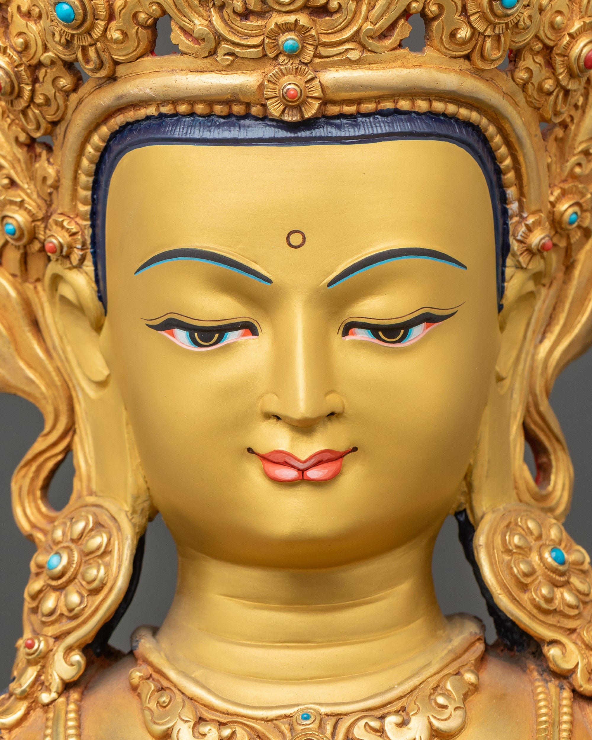 Detailed close-up of the face of Purification Buddha statue, serene expression, gold fire-gilded