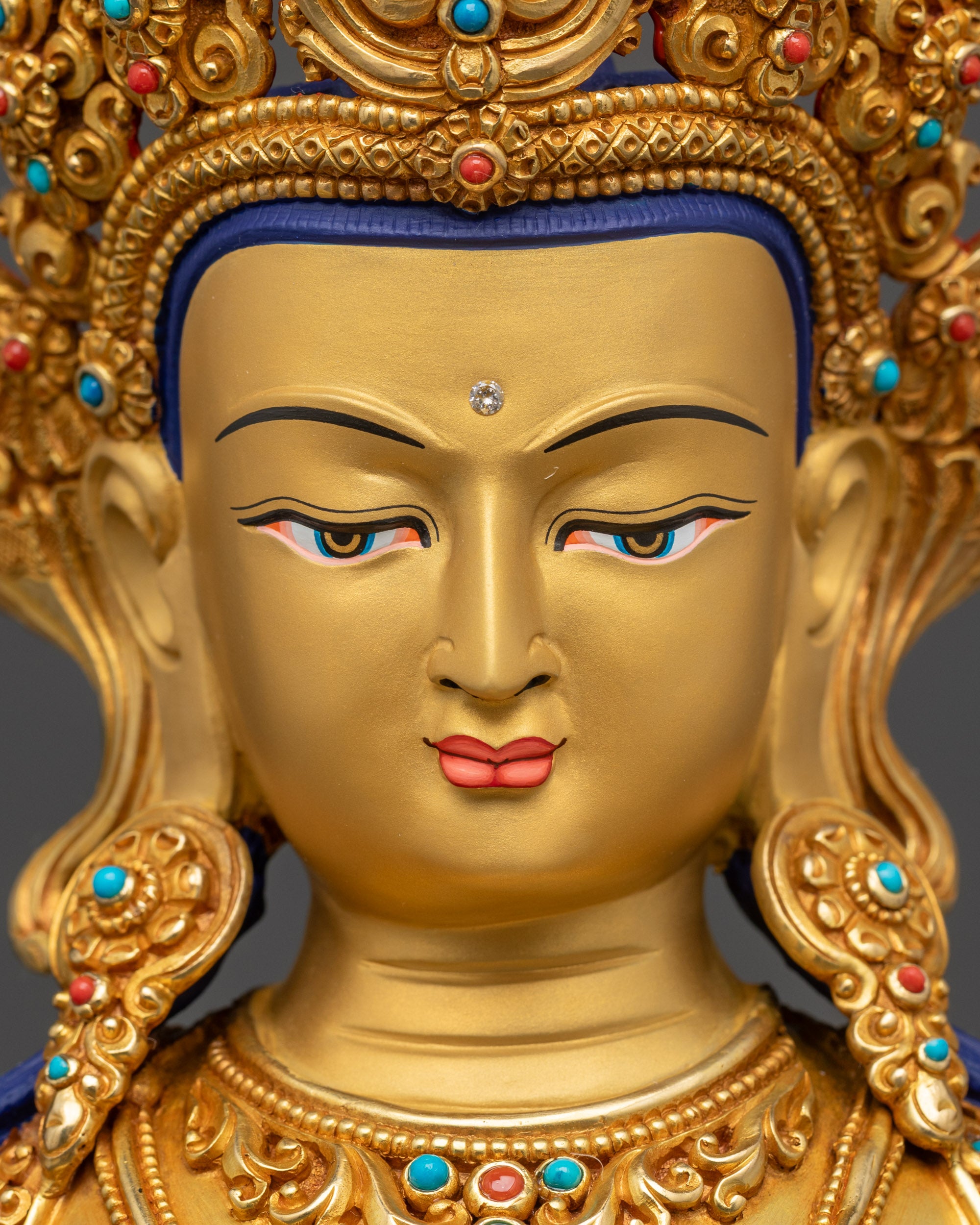 Detailed close up face Amitayus serene gold-gilded face with crown and intricate earrings