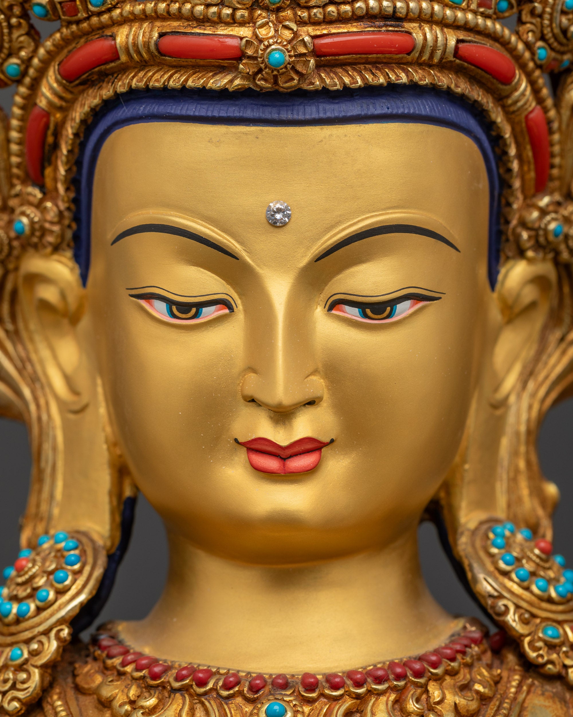 Detailed close up face Chenrezig gold-gilded Avalokiteshvara serene expression Nepal