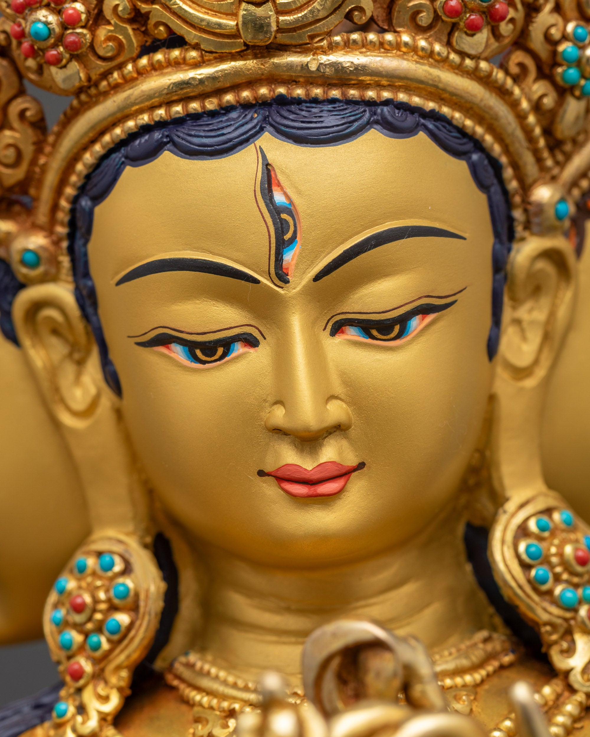 Detailed close up face Namgyalma three heads with unique facial expressions gold-gilded finish