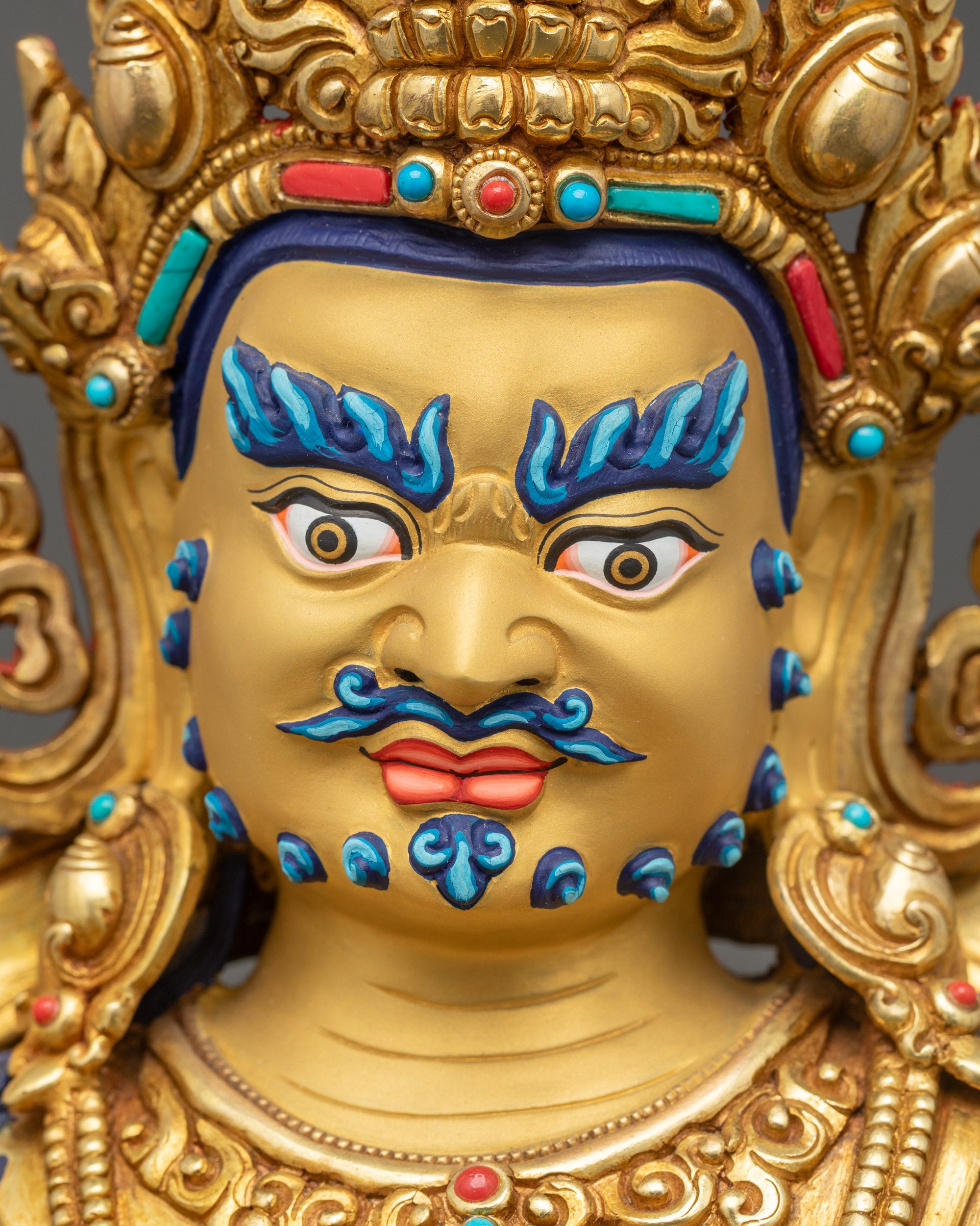 Detailed close up face Namtoshe Vaishravana statue serene expression gold gilded
