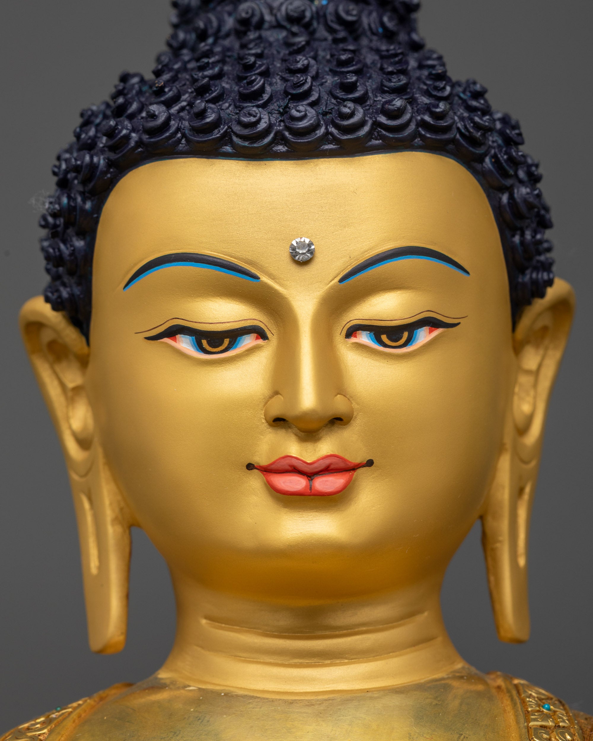 Detailed close up face Shakyamuni Buddha gold-gilded serene expression copper alloy