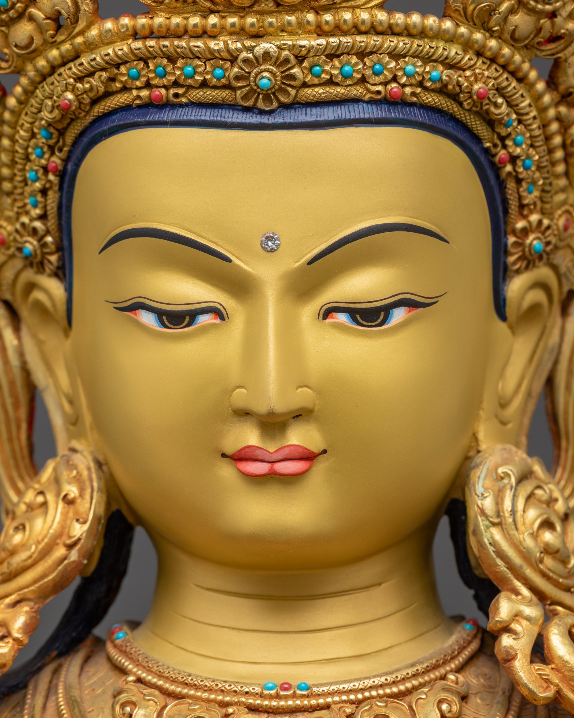 Detailed close up face of Amitayus Buddha showing serene expression and jewel crown