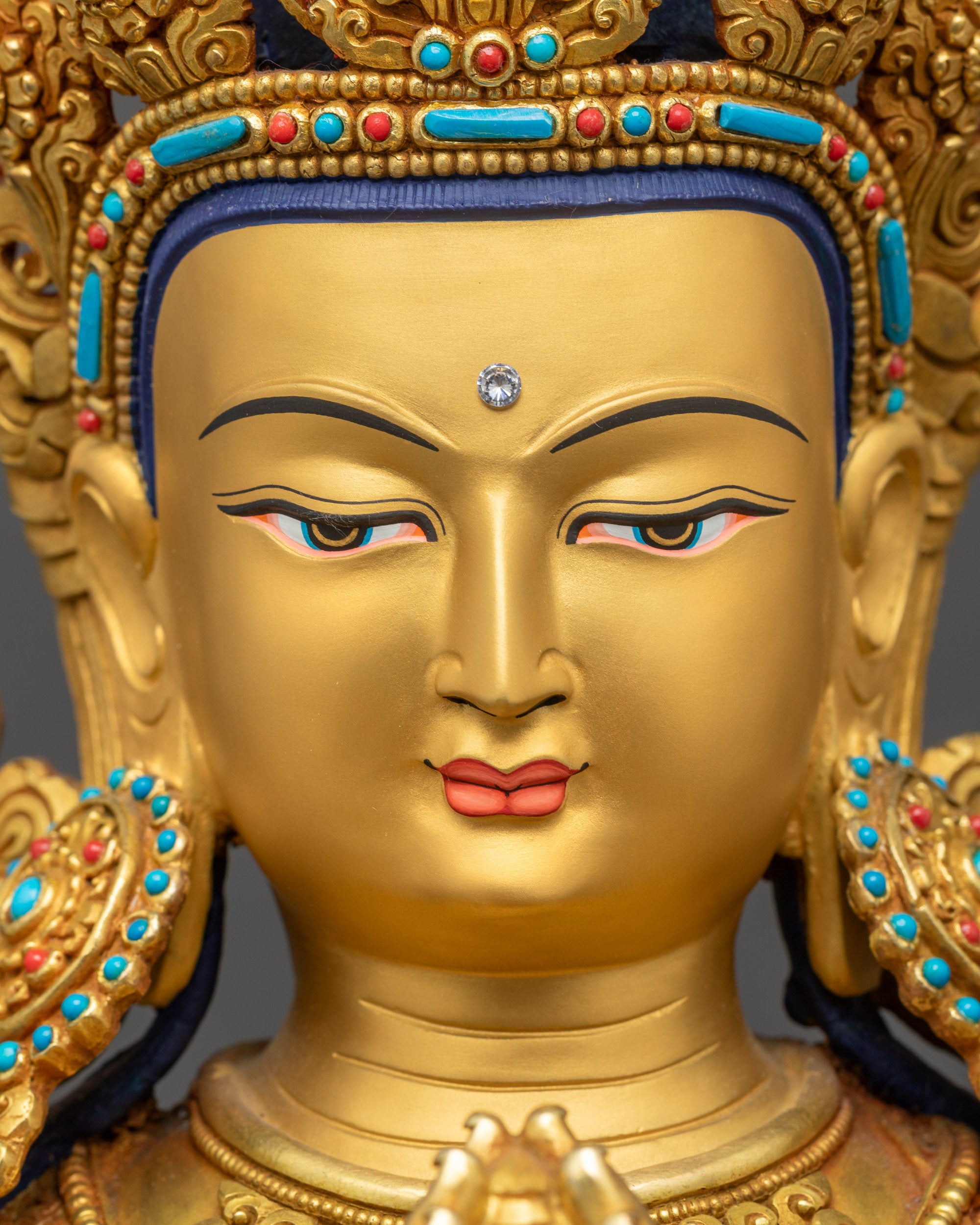 Detailed close up face of Bodhisattva Chenrezig holding sacred objects