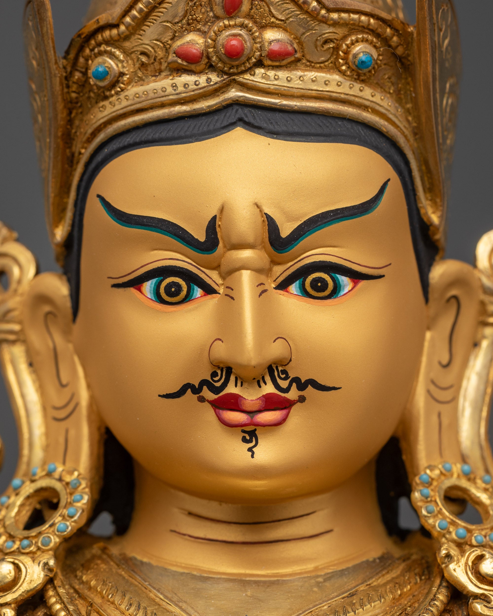 Detailed close up face of Guru Rinpoche with semi-wrathful expression