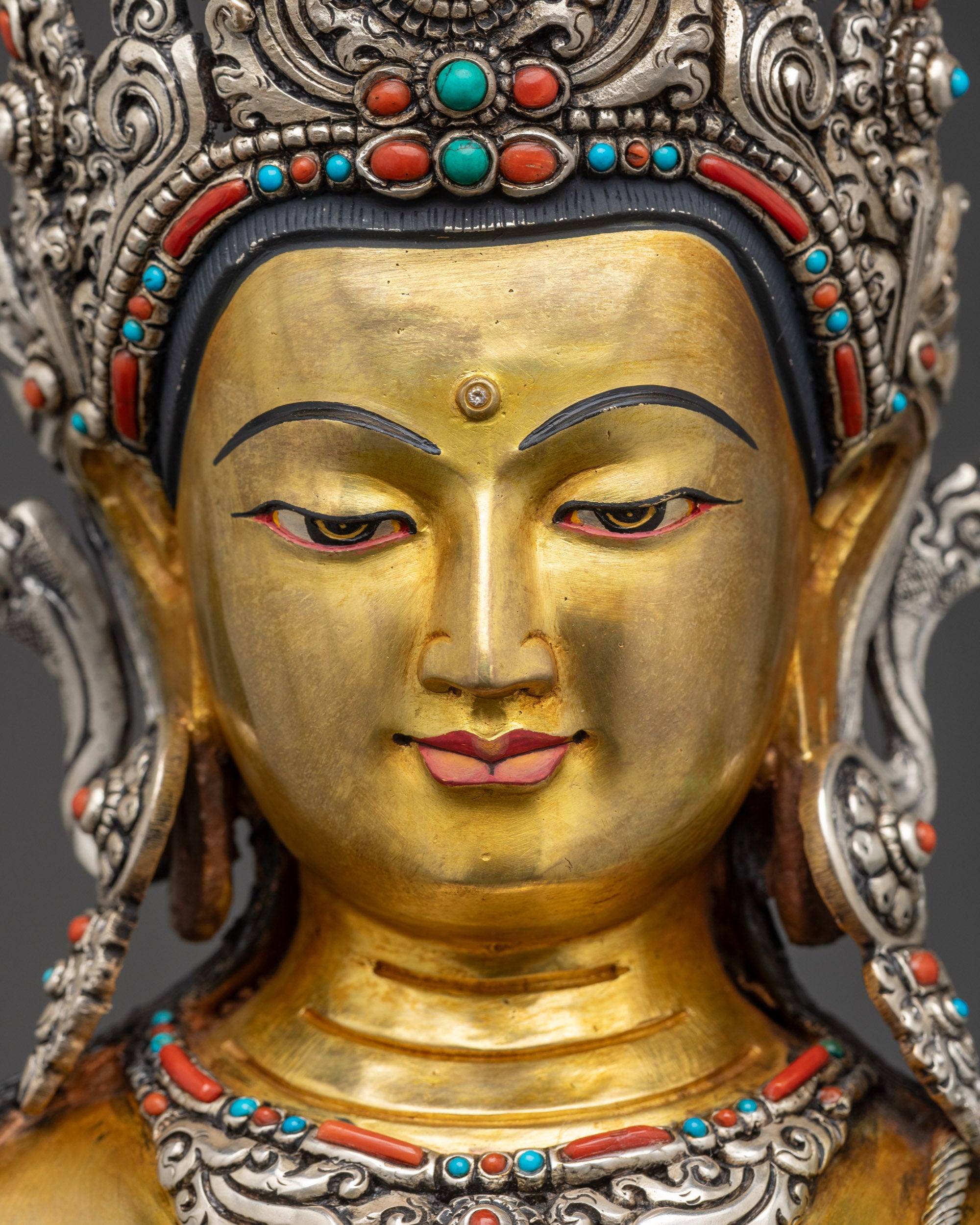 Detailed close up face of Lokeshwor statue with silver crown and peaceful gaze