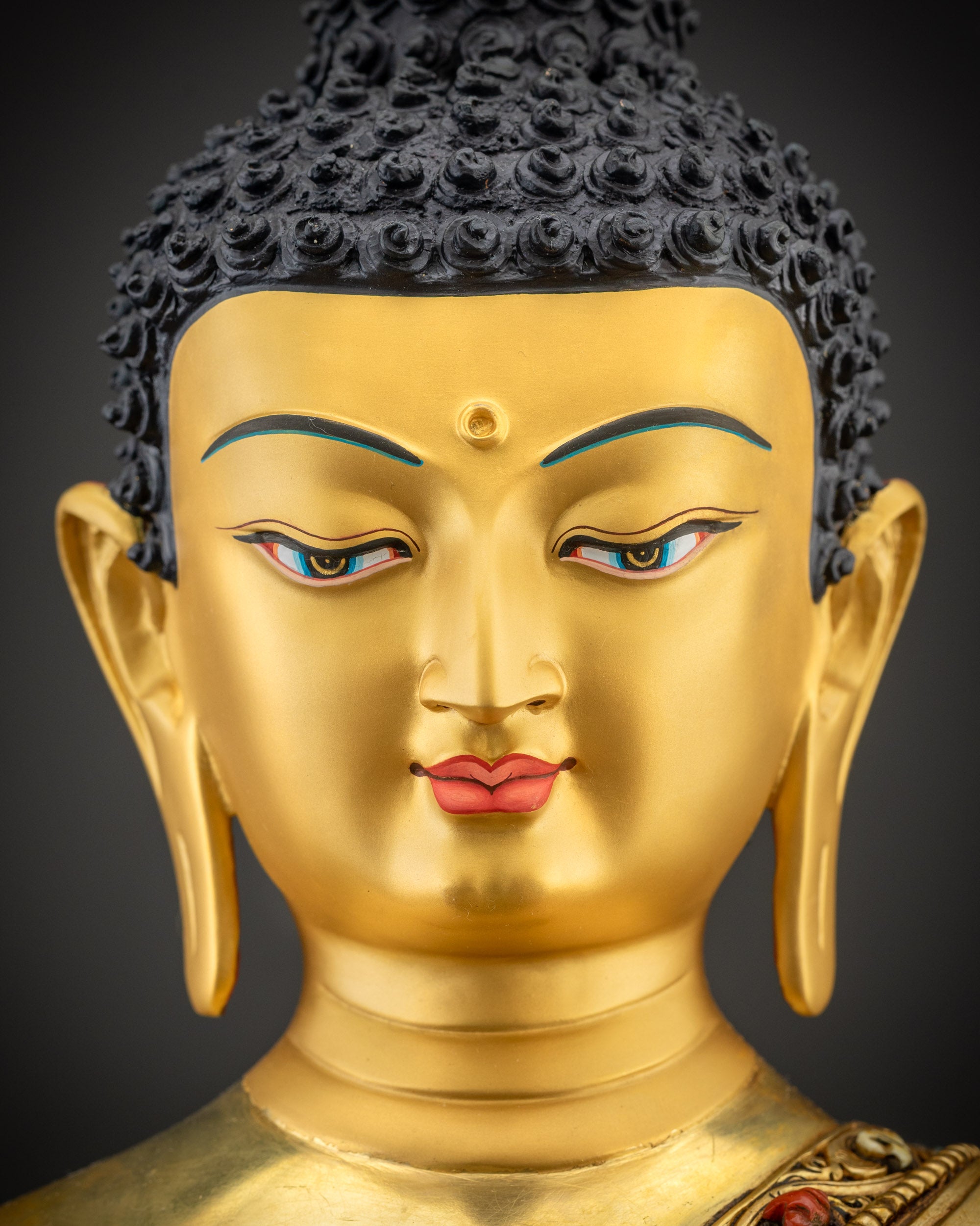 Detailed close up face of Medicine Buddha showing serene expression and intricate halo design