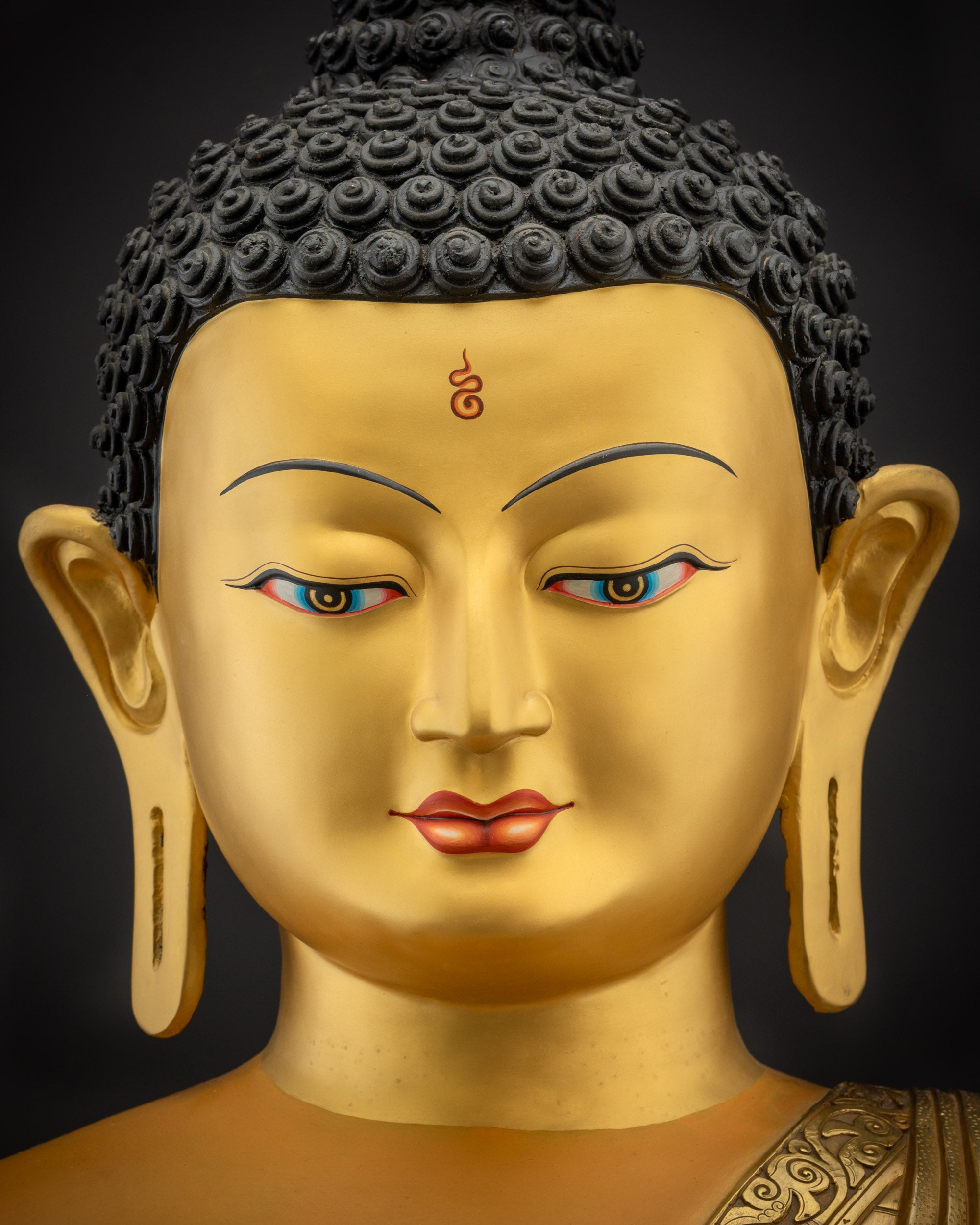 Detailed close up face of Shakyamuni Buddha Siddhartha Gautama gold-gilded face