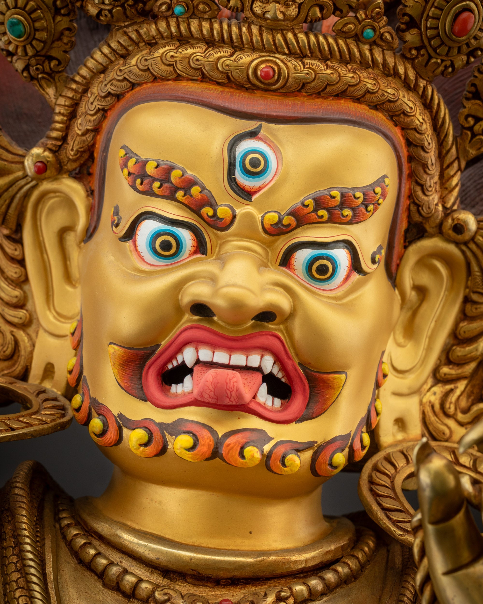 Detailed close up face of Vajrapani Statue highlighting fierce expression and third eye
