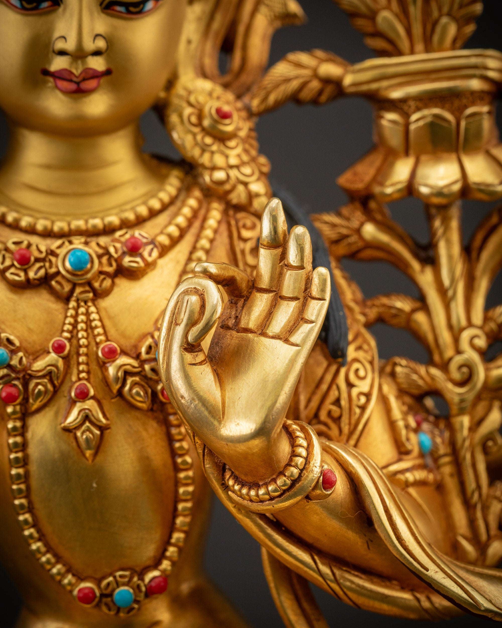 Detailed close up of Maha Manjushri statue showing hand posed granting mudra