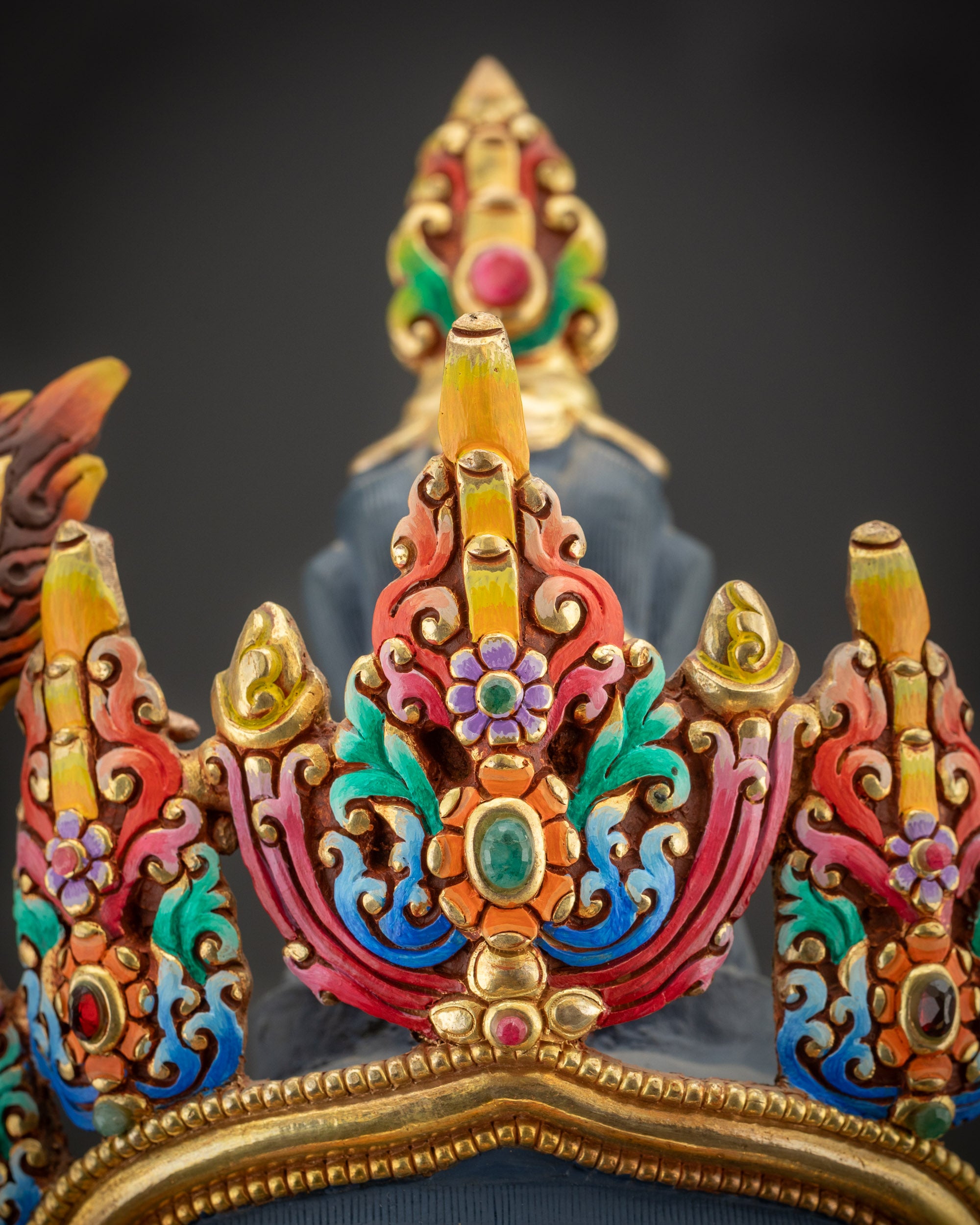 Detailed close up of Manjushri crown showing gold-plated ornaments and intricate carvings