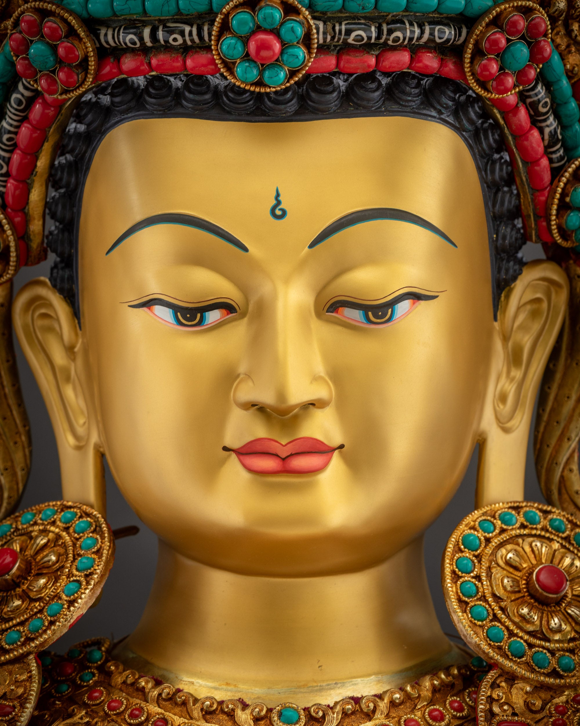 Detailed close up of face Shakyamuni Buddha gilded face with peaceful spiritual gaze
