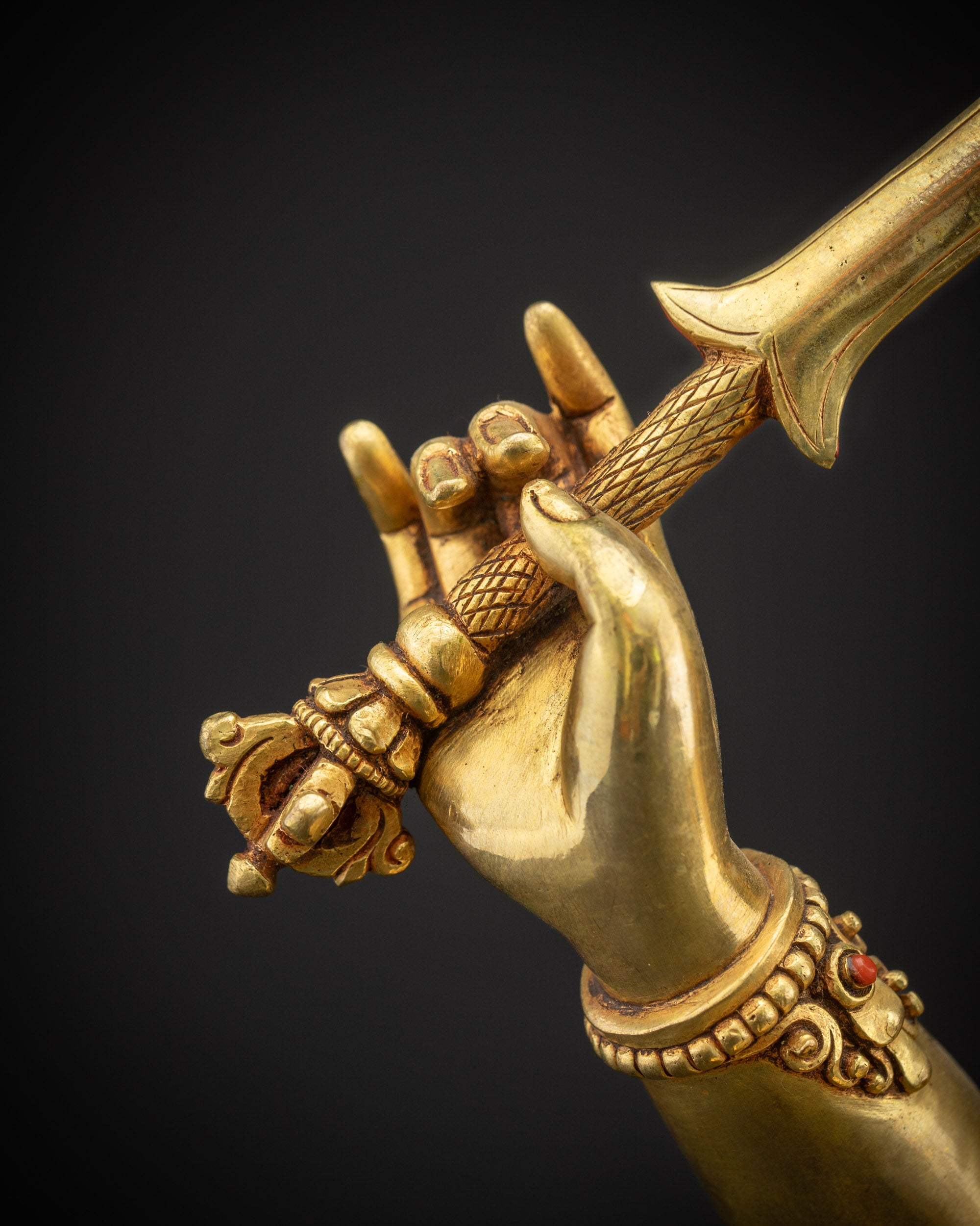 Detailed close up of flaming sword of wisdom held by Manjushri Statue