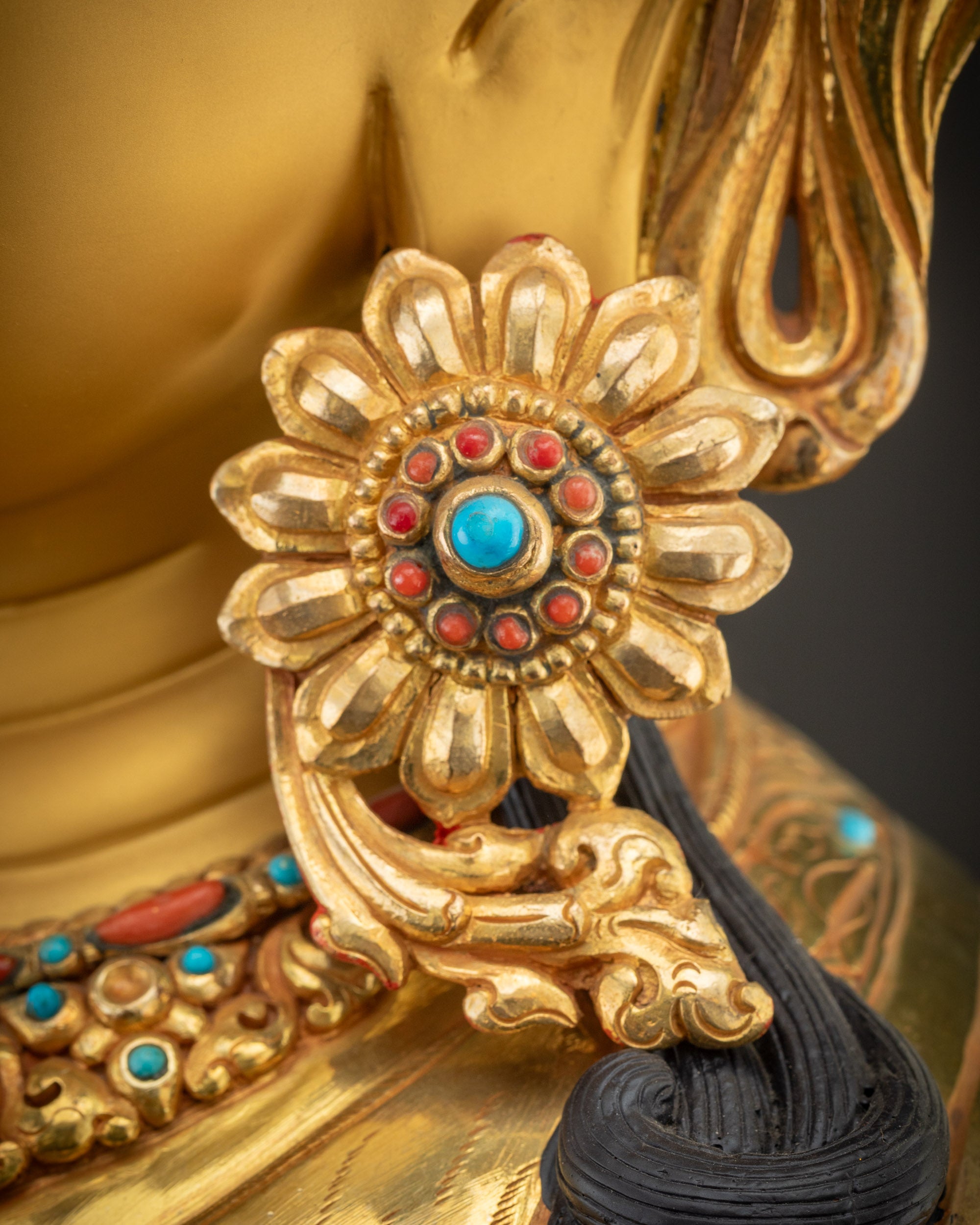 Detailed earrings of Chenrezig Statue showing artisan-carved semi-precious stone detailing