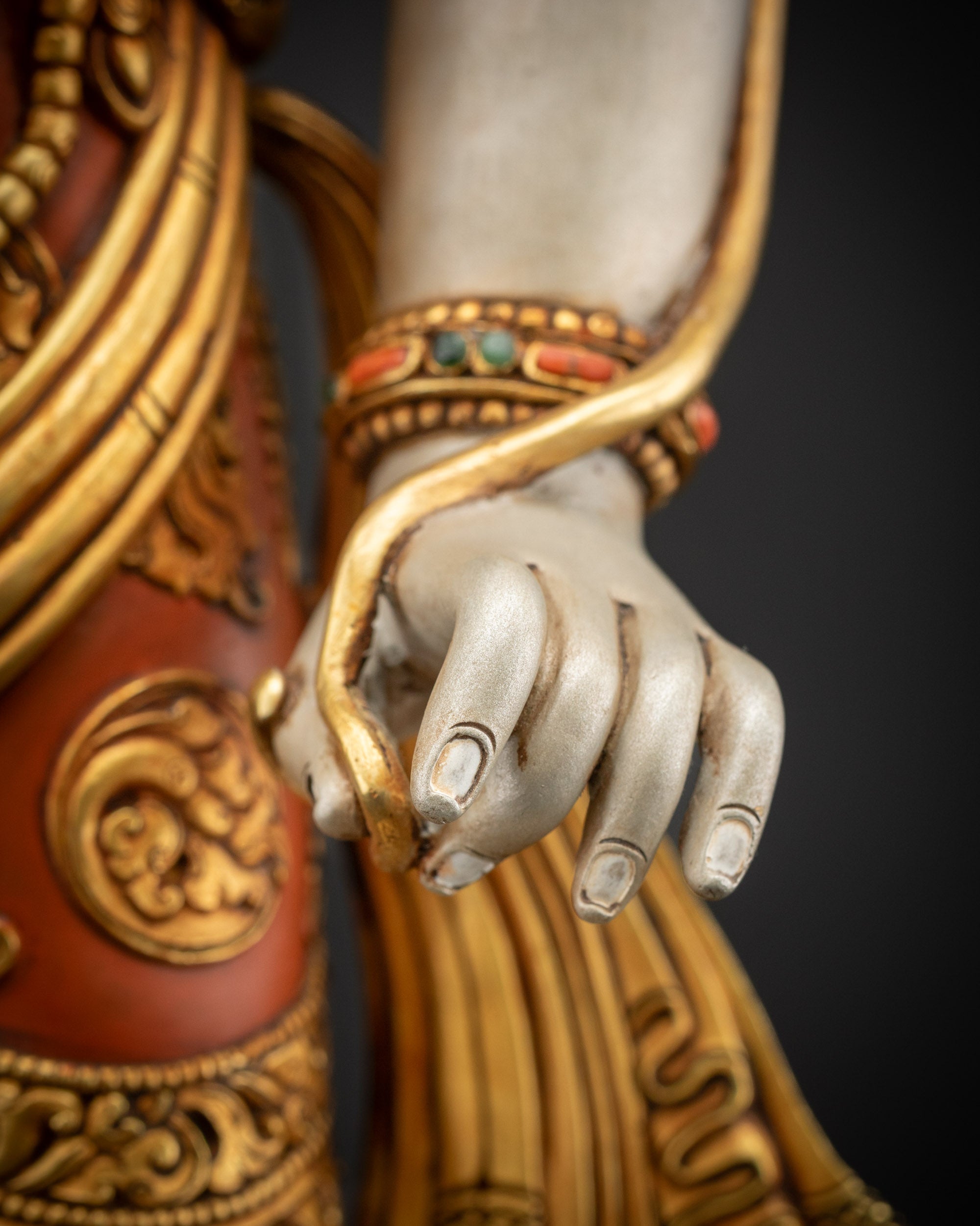 Detailed holding stem close up showing Utpala flower in Lokeshvara’s hand