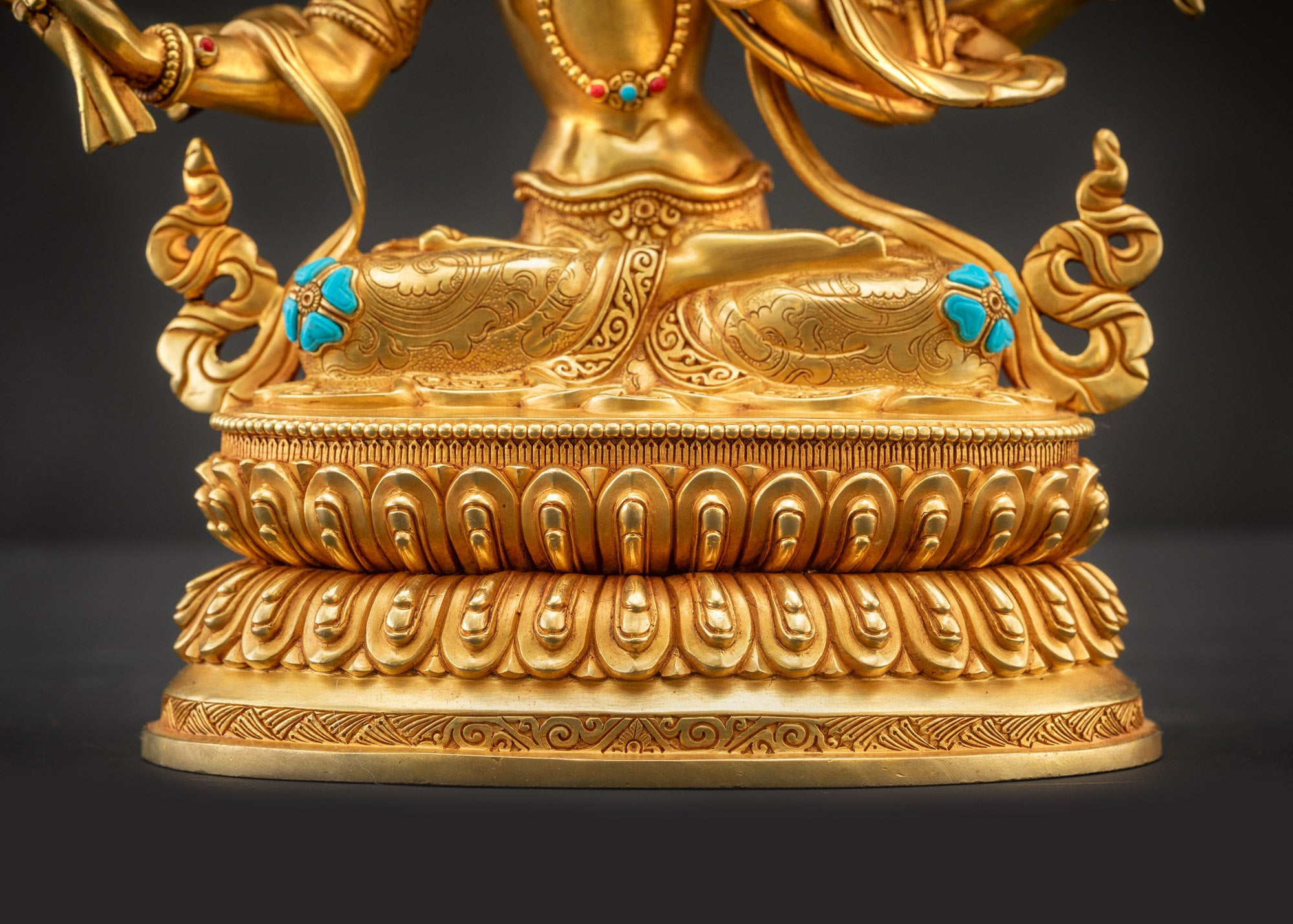 Detailed landscape front view of statue seated on lotus showing full gold-gilded sacred figure