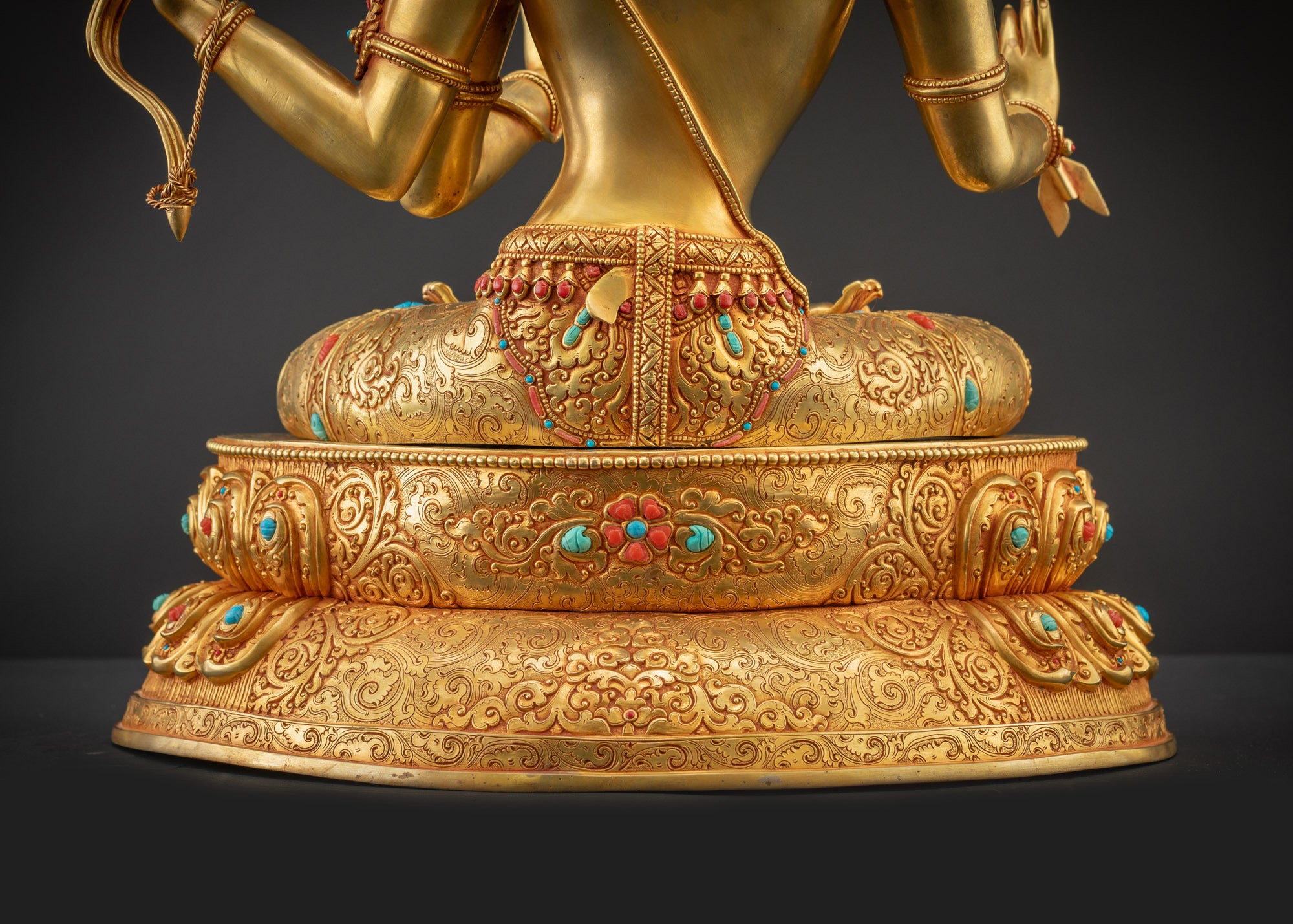 Detailed landscape shot back Maha Manjushri Statue seated on lotus base with intricate carvings