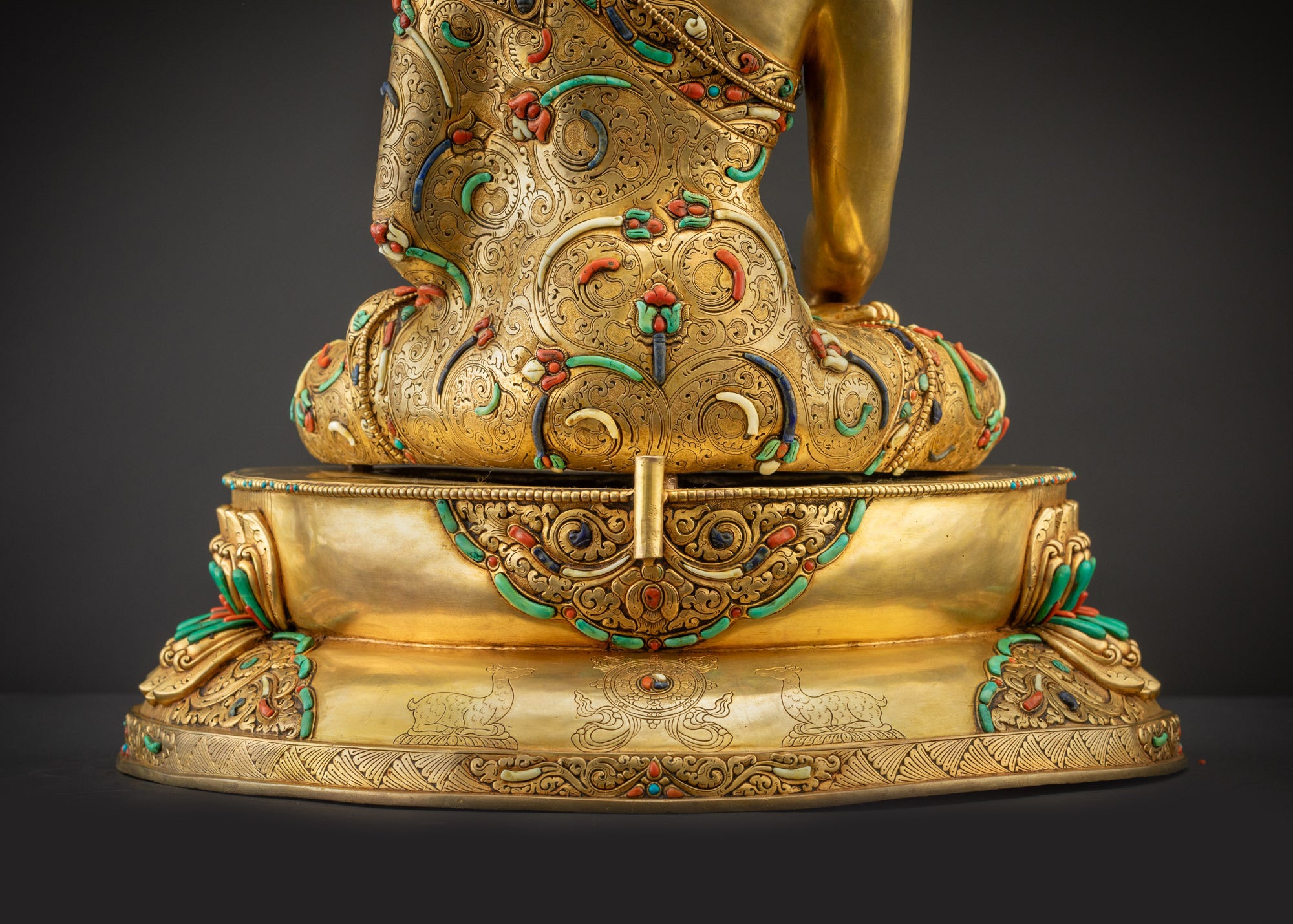 Detailed landscape shot back view of statue seated on lotus base showing robe details