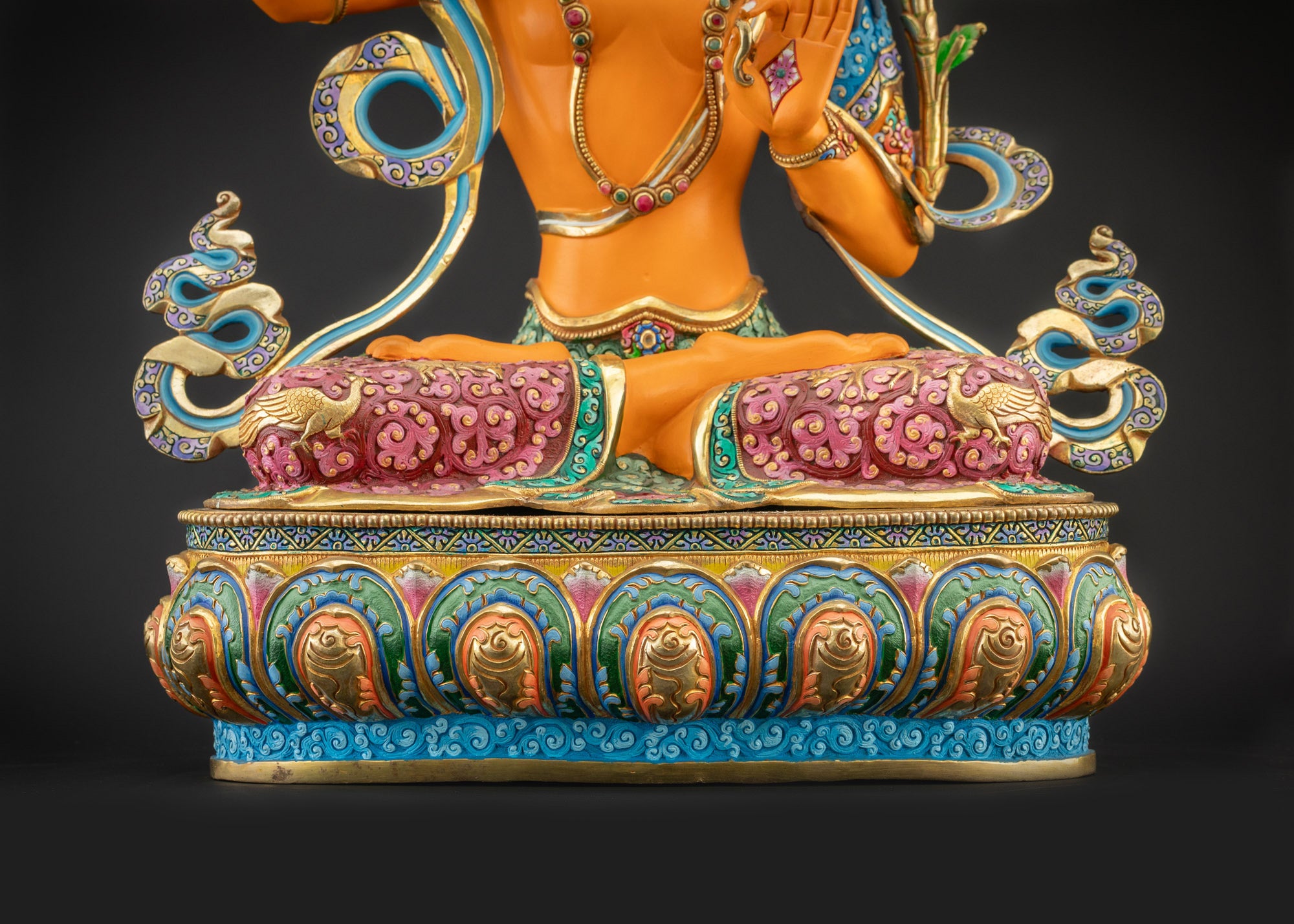 Detailed landscape shot of Manjushri statue seated on lotus seat front view