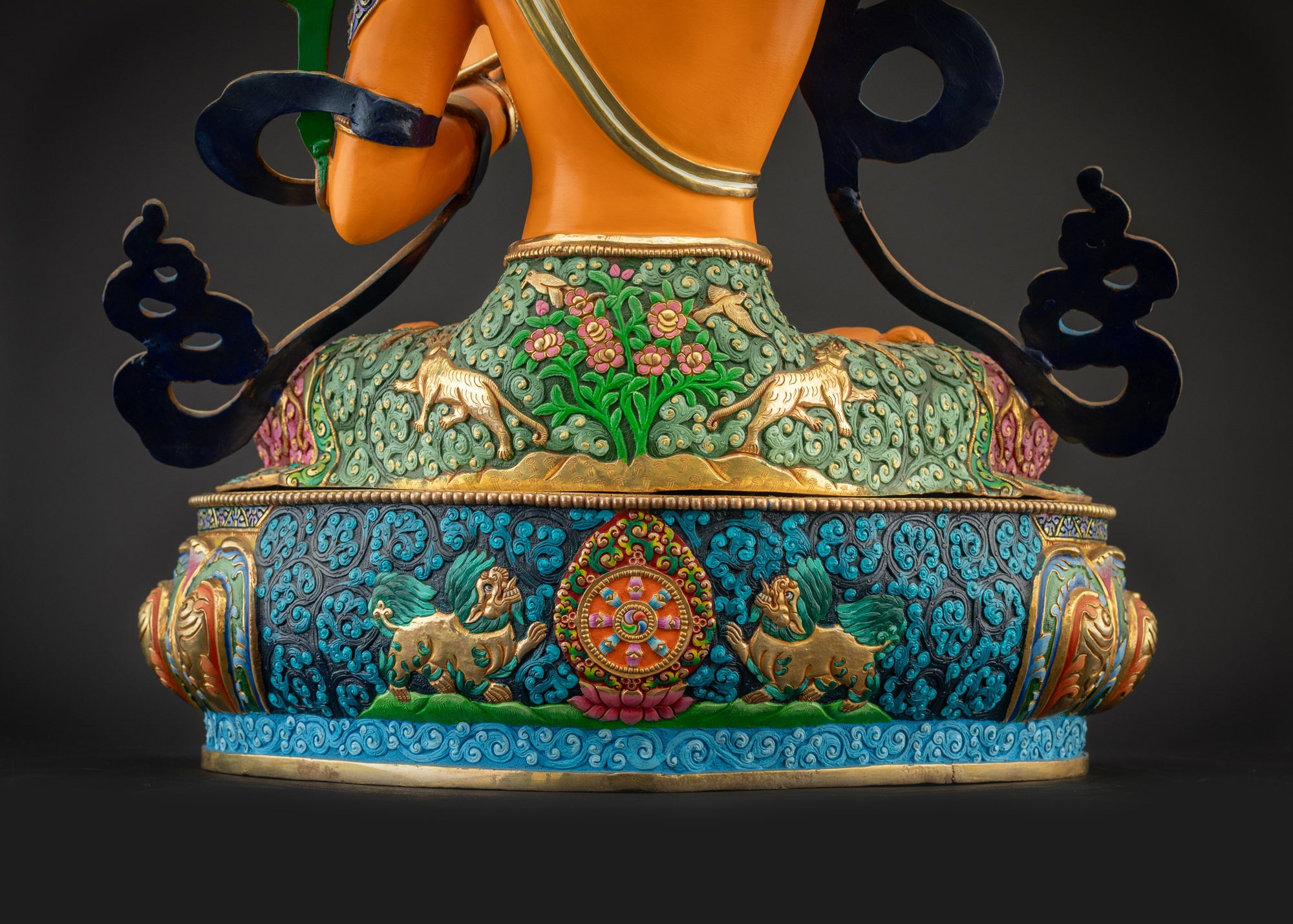 Detailed landscape shot of Manjushri statue seated on lotus seat back view