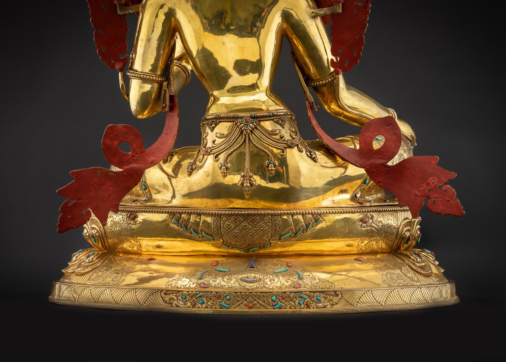Detailed landscape shot of statue seated on lotus seat back Green Tara back view meditation statue