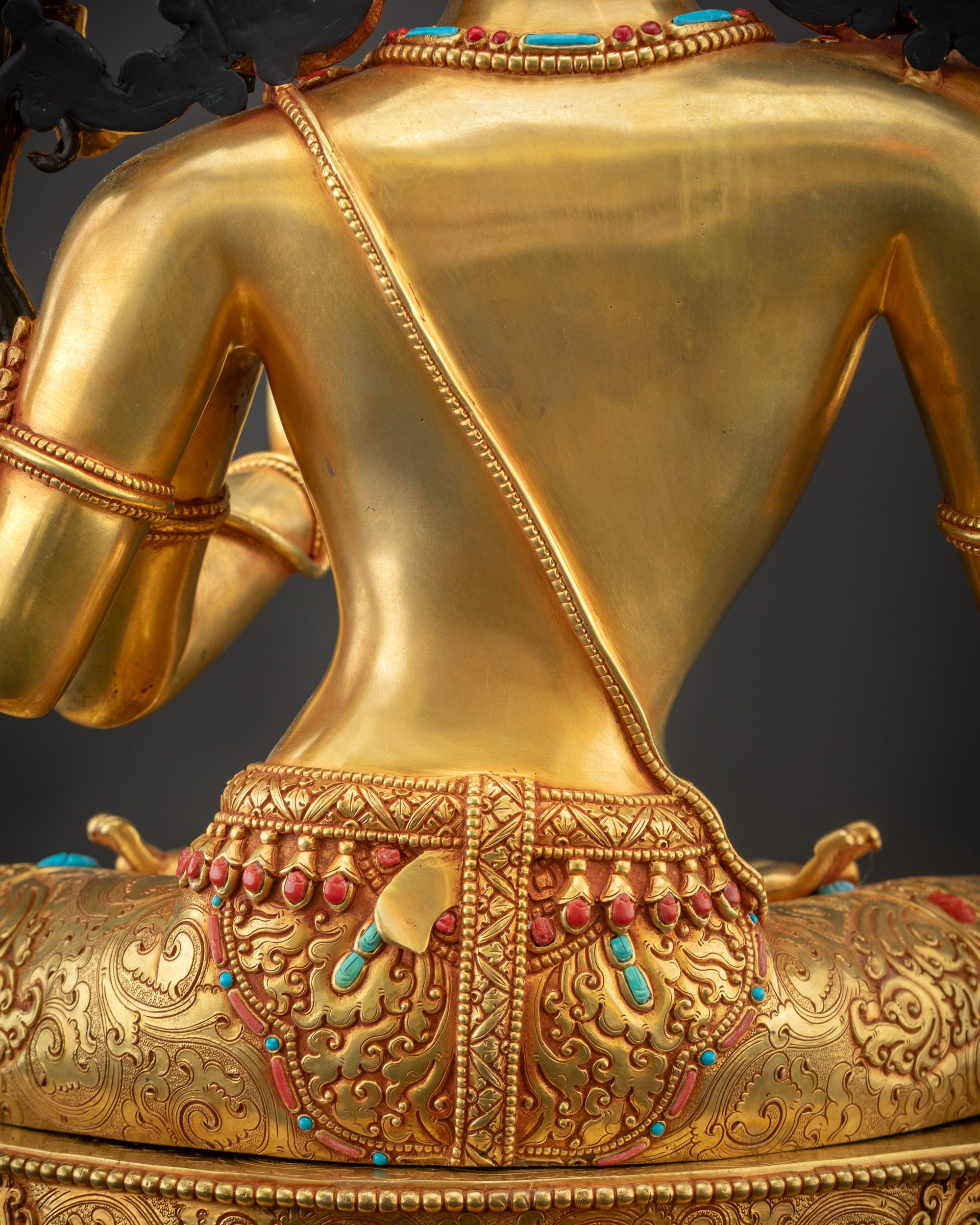 Detailed shot Maha Manjushri Statue robe and inlaid semi precious stones with luminous reflection