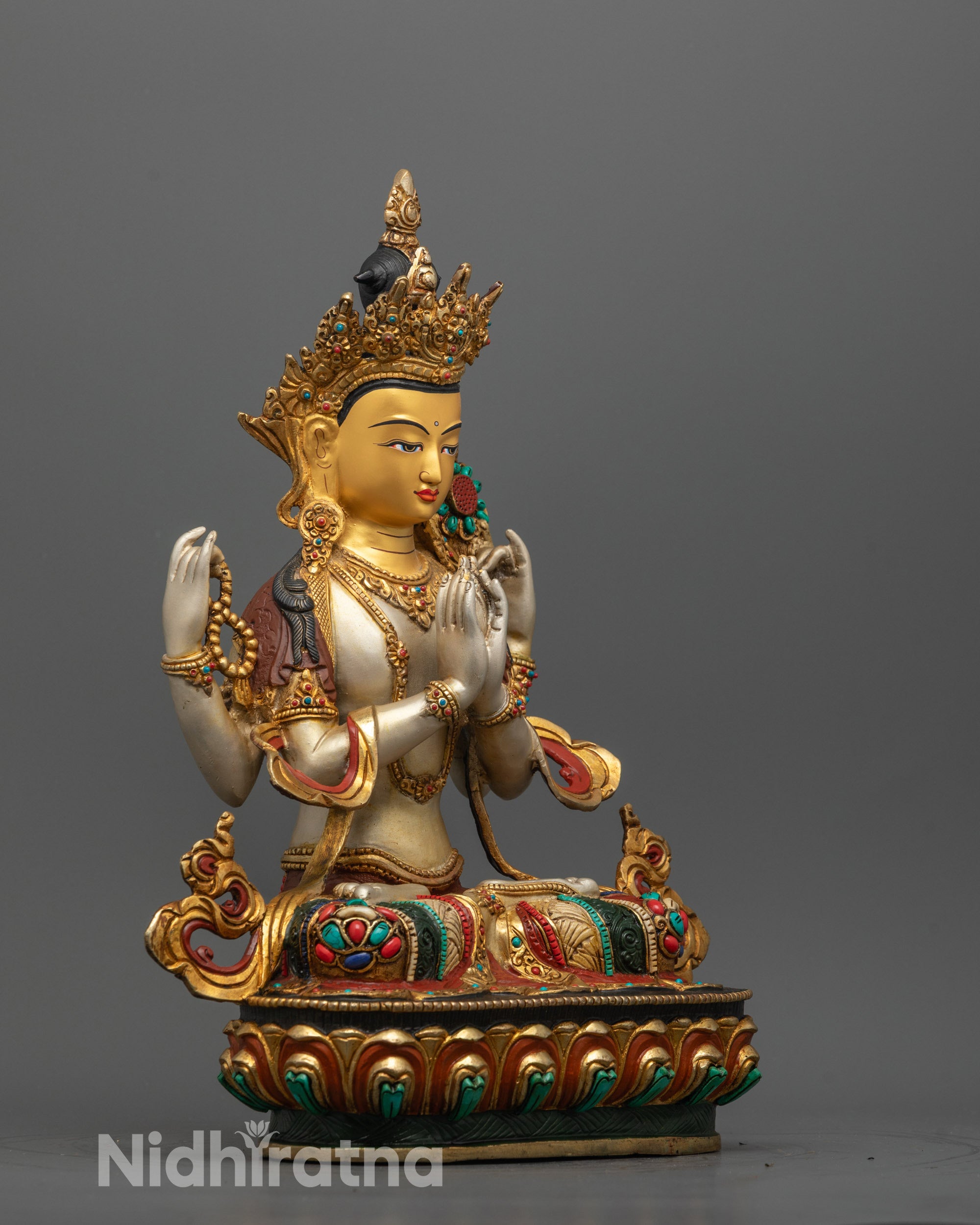 Detailed shot of 24k gold-gilded face and symbolic objects on hand-carved Chenrezig Statue