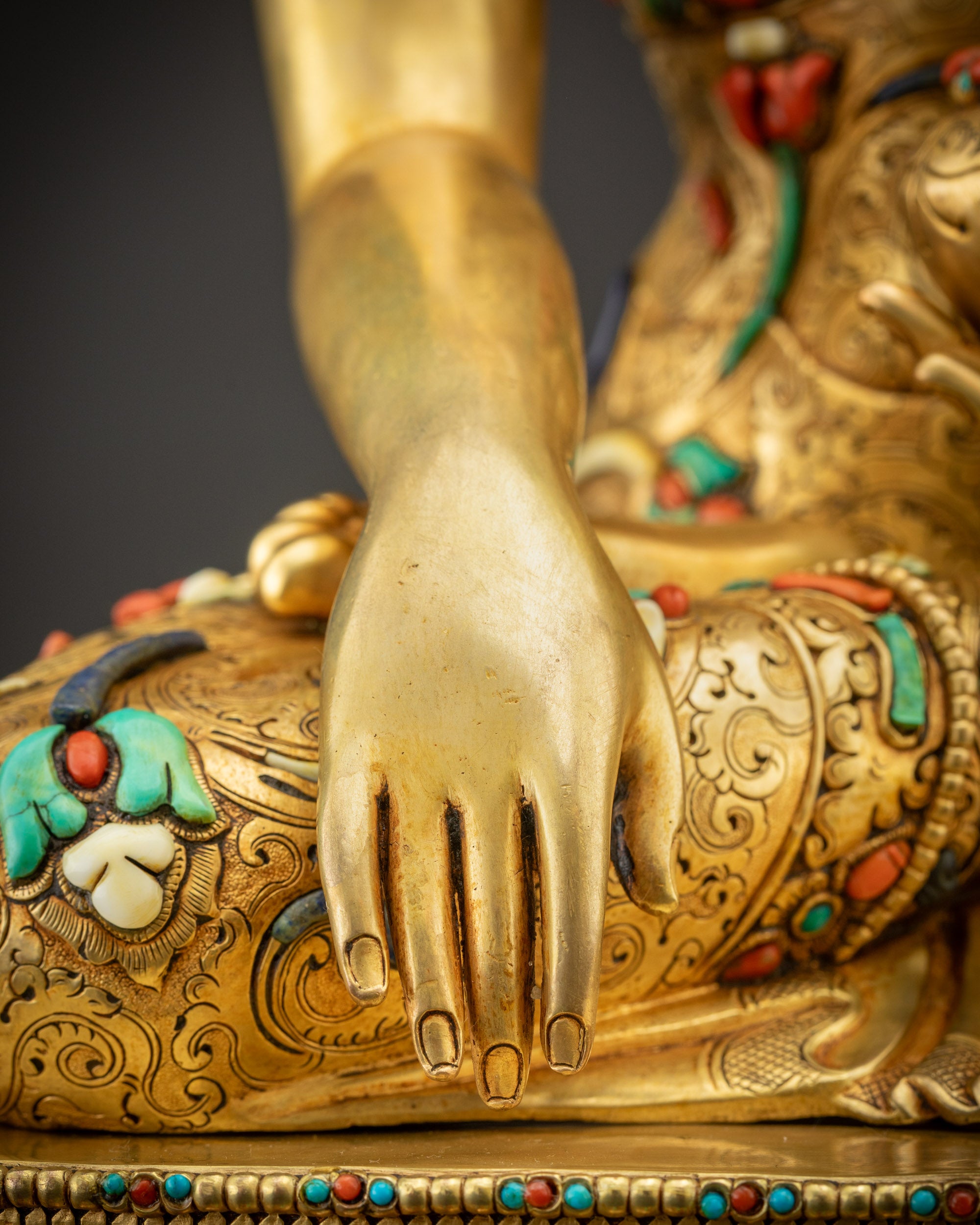 Detailed shot of Bhumisparsha Mudra hand gesture symbolizing Buddha’s enlightenment