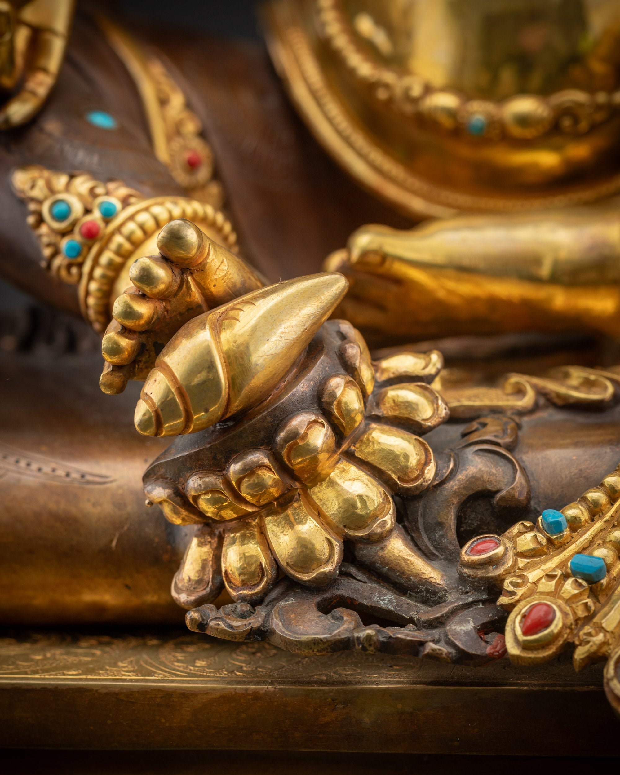 Detailed shot of Dzambhala statue seated on lotus with oxidized throne details