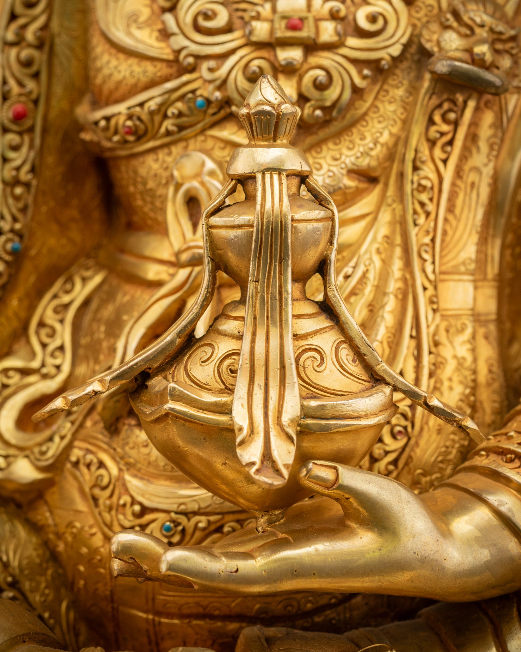 Detailed shot of Guru Rinpoche holding skull cup with vase of immortality