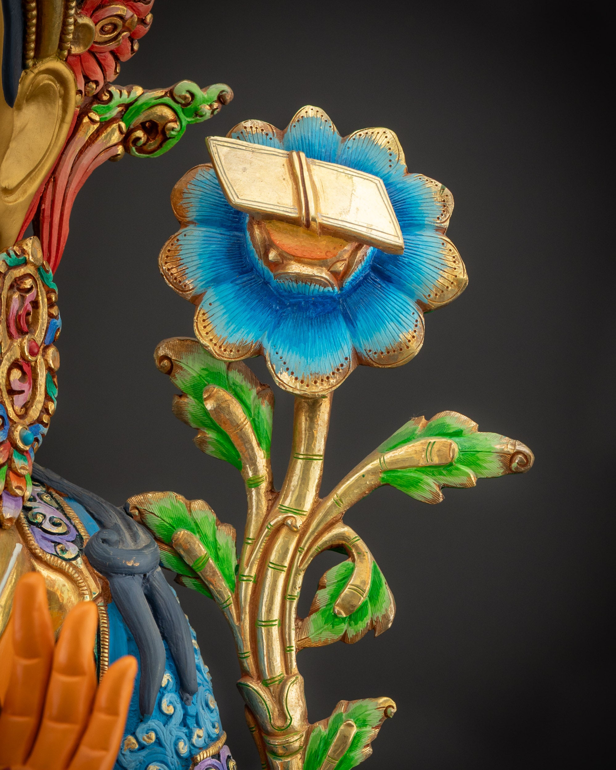 Detailed shot of Manjushri statue utpala stem with sutra crowned