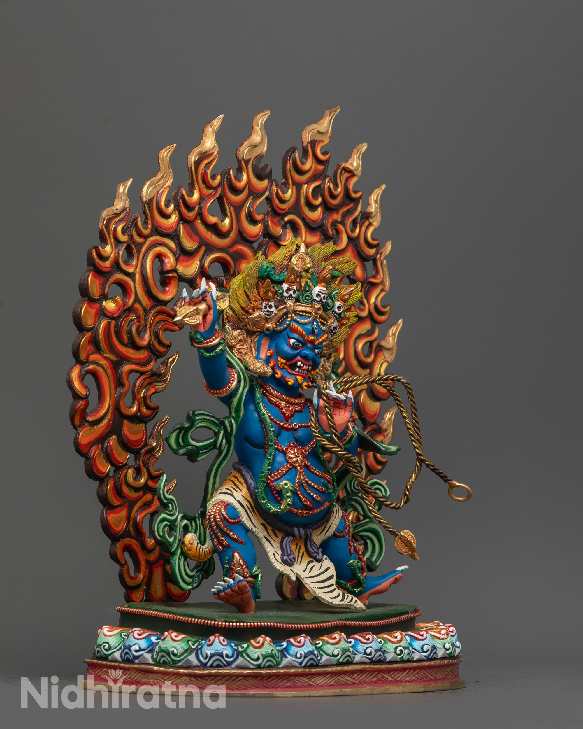 Detailed shot of blue copper body and gold-accented face of Vajrapani Statue