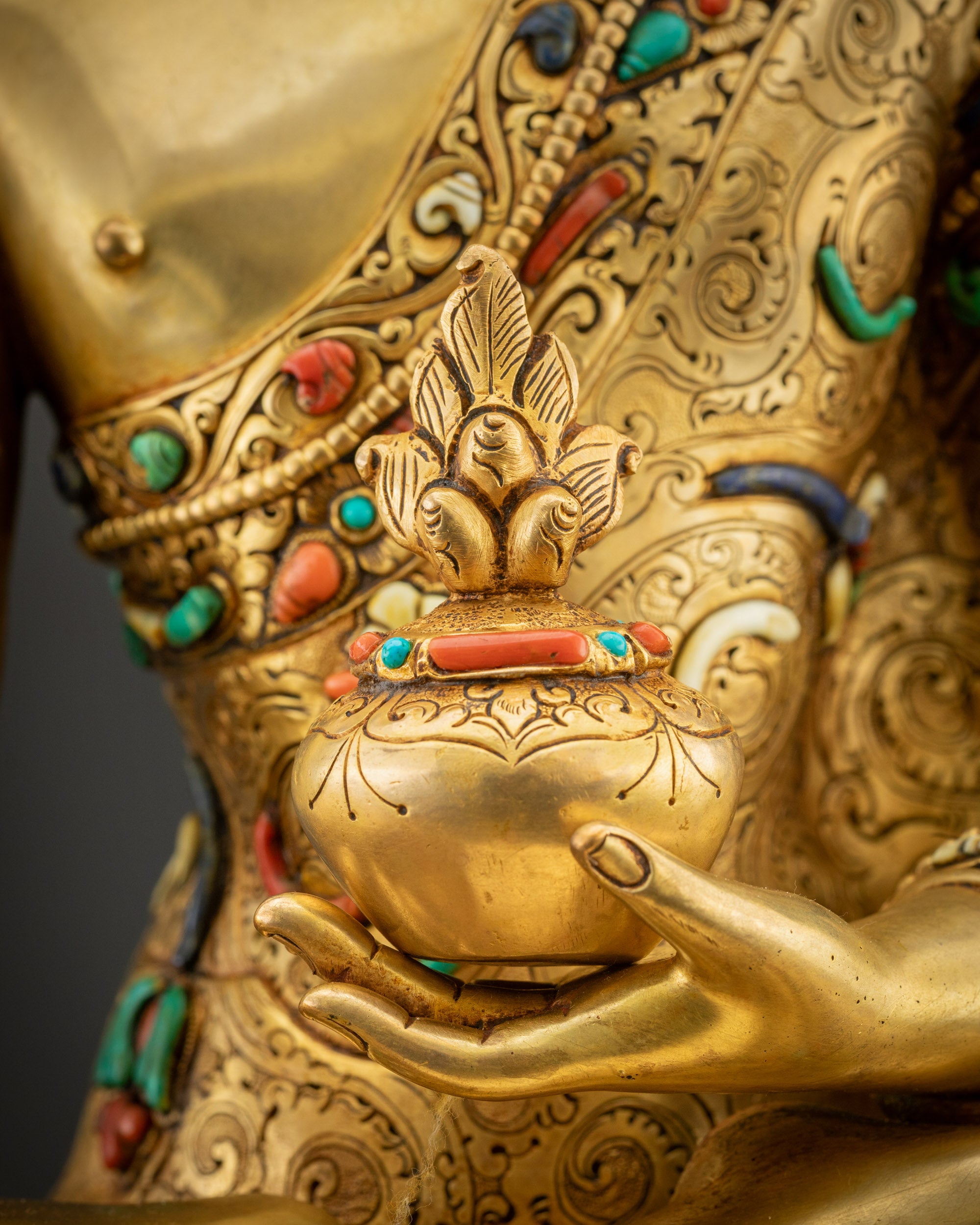 Detailed shot of bowl of healing herbs held by Medicine Buddha showing gold and intricate details