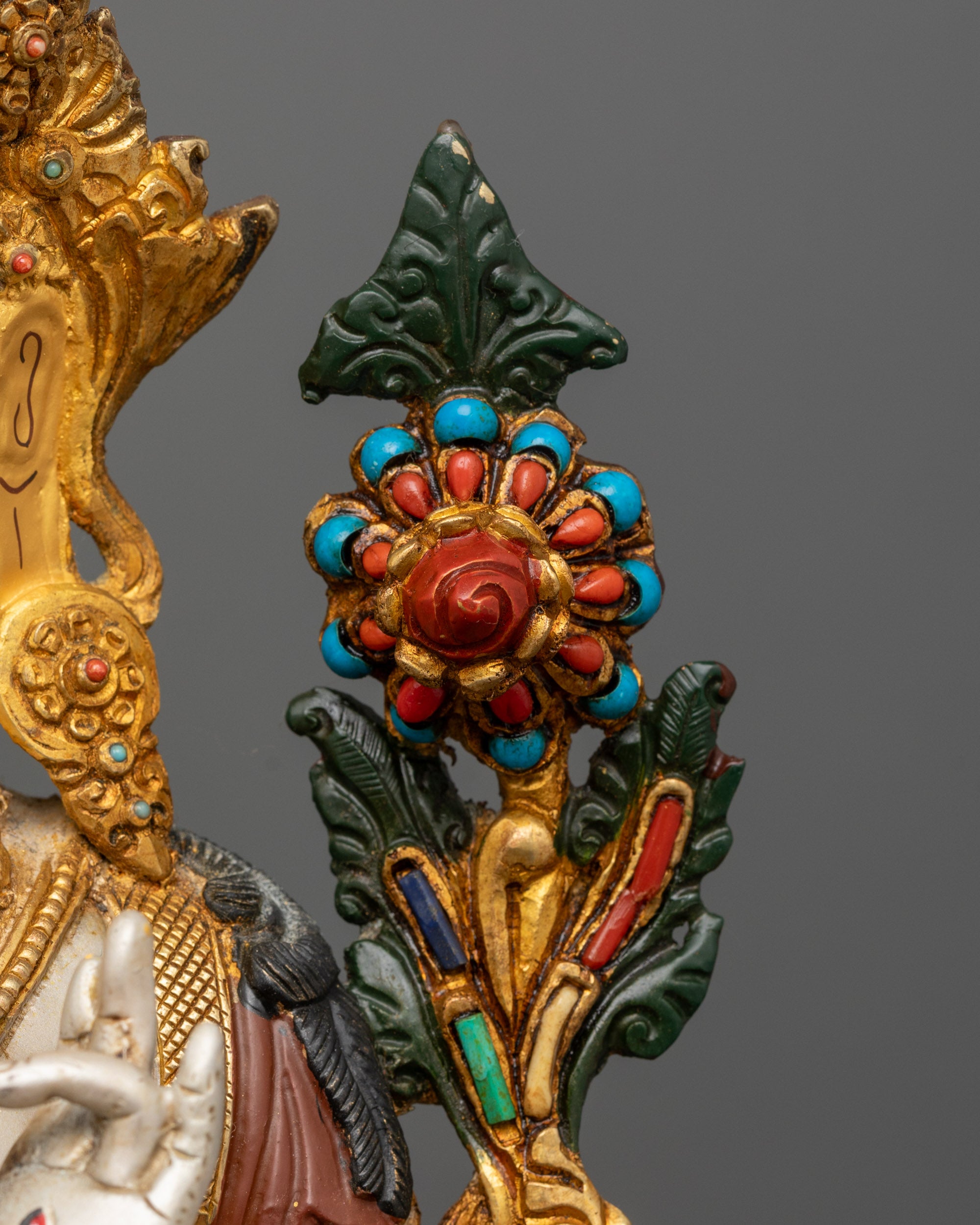 Detailed shot of lotus base and ornate jewelry on 24k gold-gilded White Tara Statue