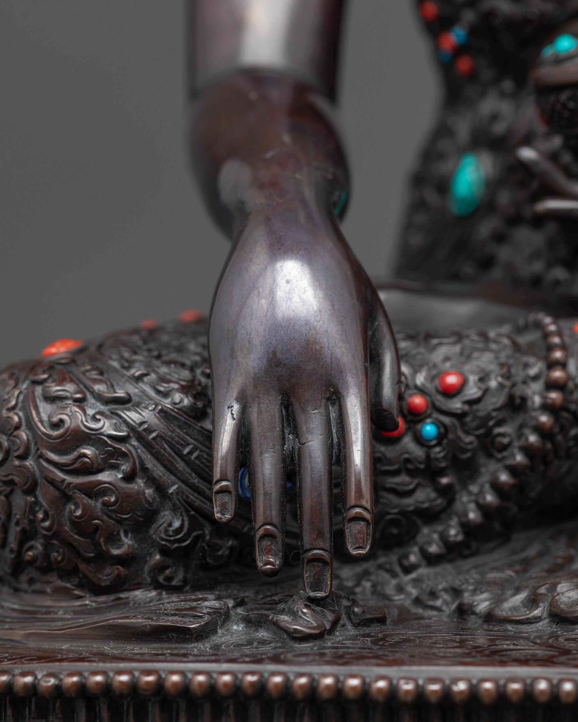 Detailed shot of mudra Buddha Shakyamuni oxidized statue holding Bhumisparsha gesture
