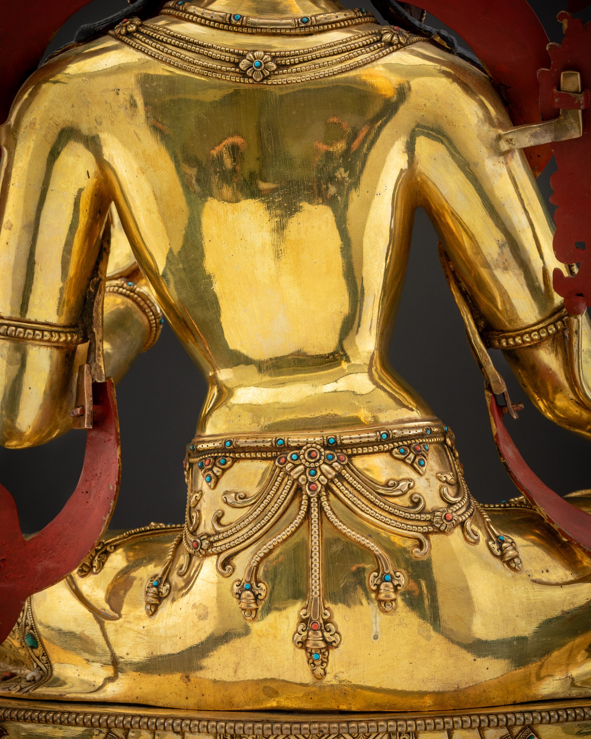 Detailed shot of robe Green Tara flowing robes hand-carved gold-gilded sacred sculpture