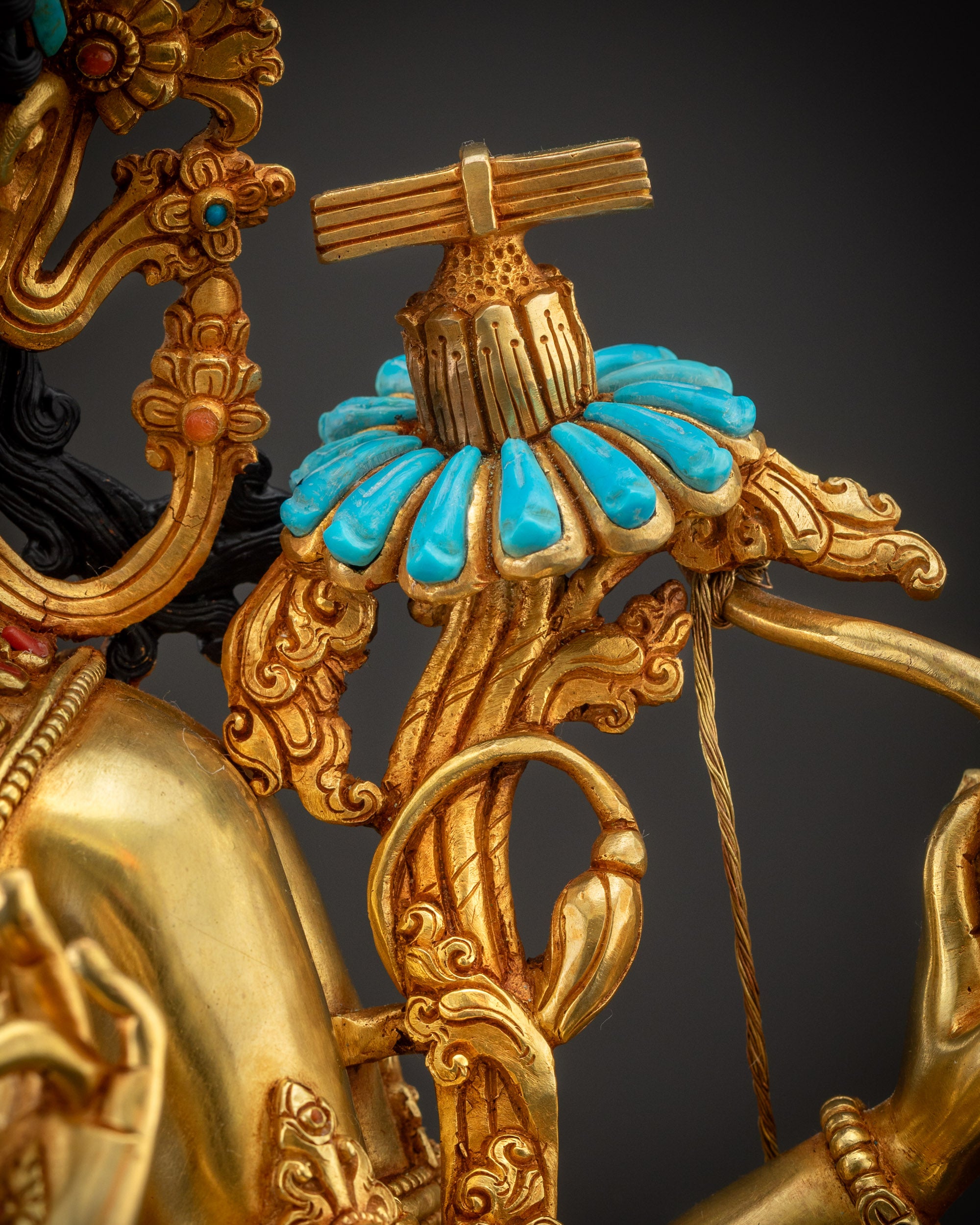 Detailed shot of utpala flower and Prajnaparamita Sutra in Maha Manjushri statue left hand.